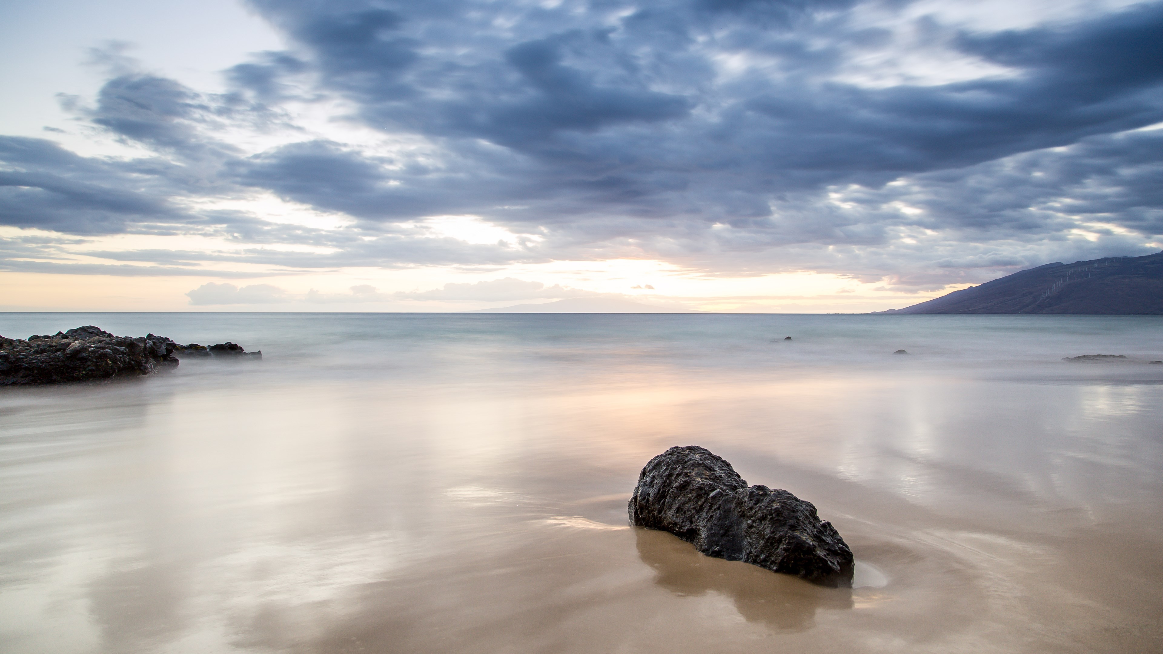 Long exposure of a rocky beach at sunset with clouds HD Wallpaper