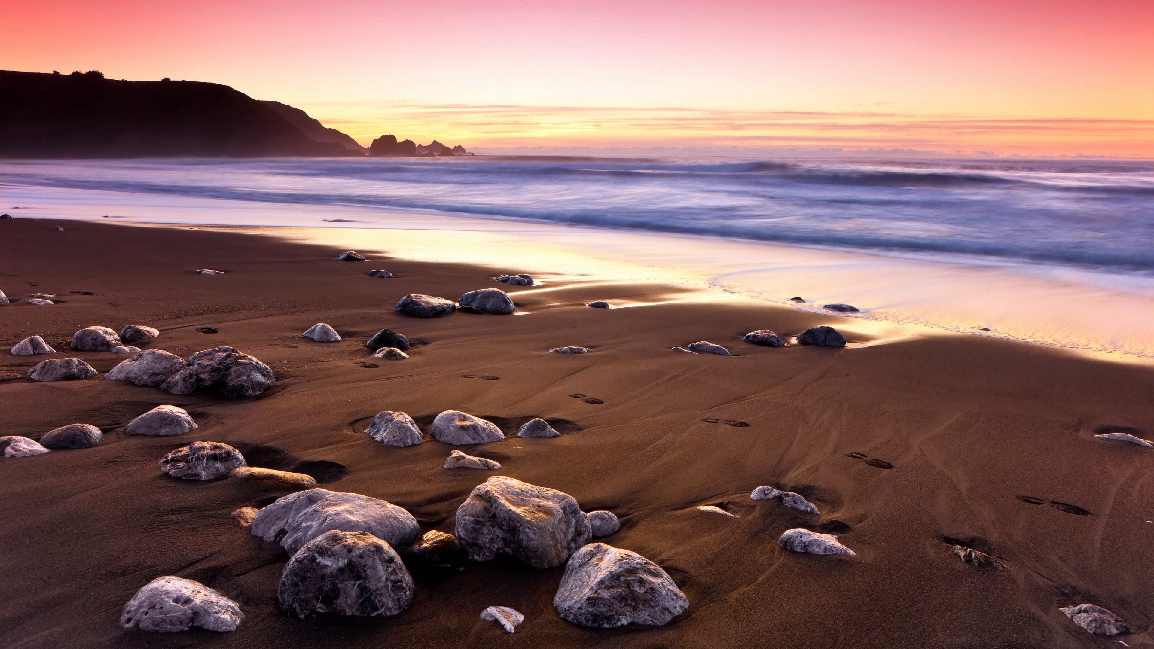 Beach with rocks and ocean at sunset HD Wallpaper