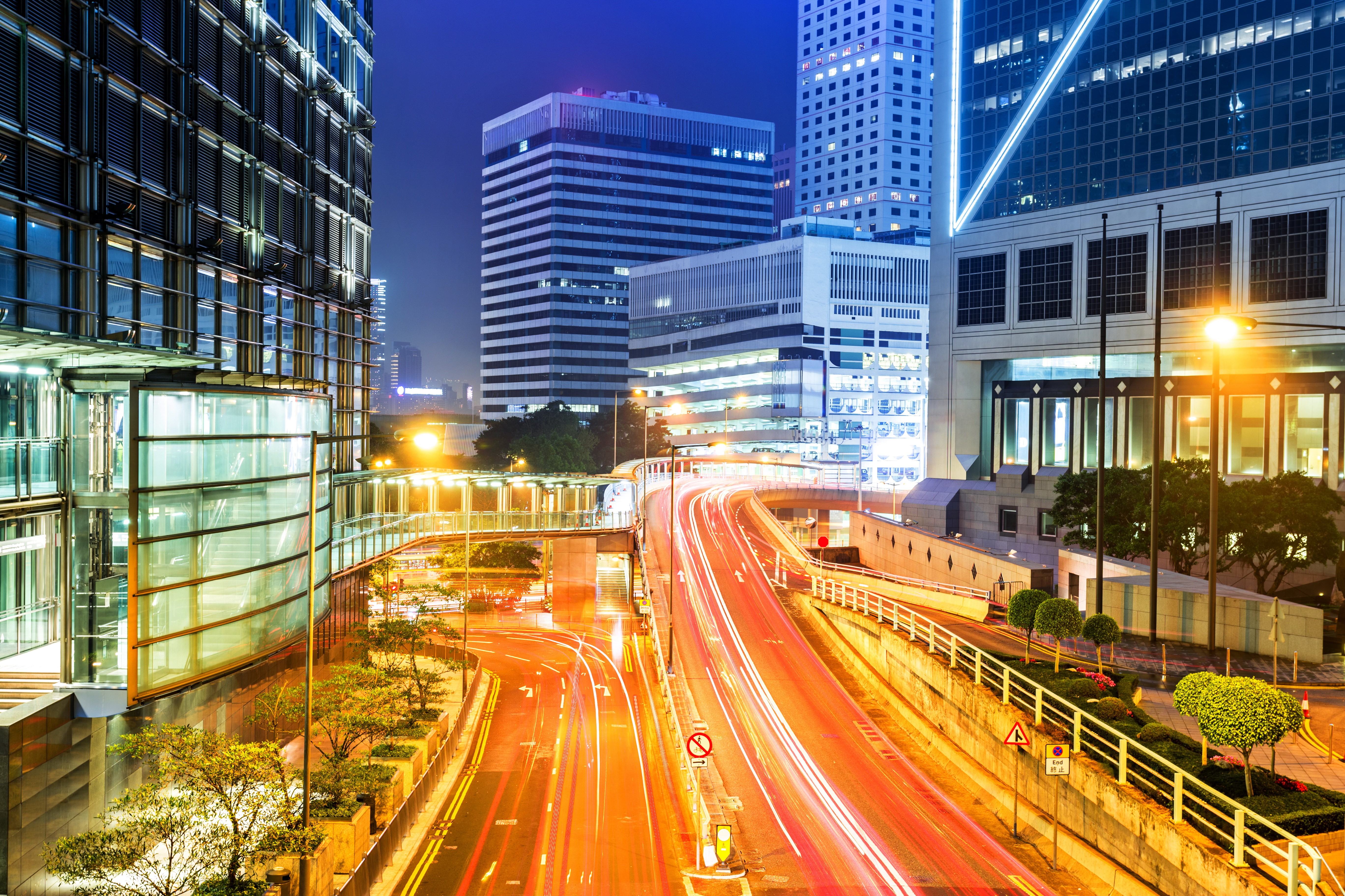 Hong Kong cityscape at night with light trails on roads HD Wallpaper
