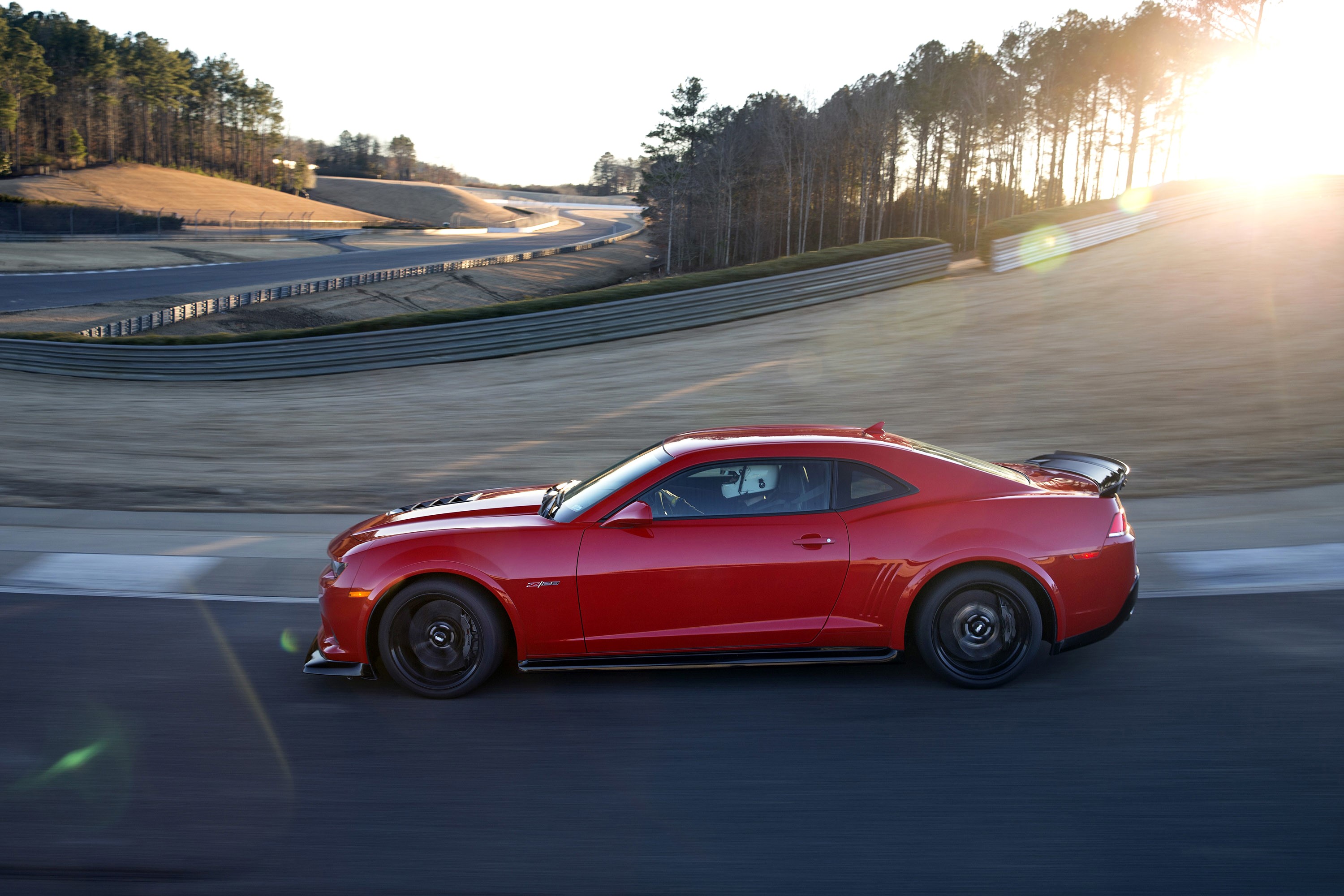 Red 2015 Chevrolet Camaro Z28 on a race track HD Wallpaper