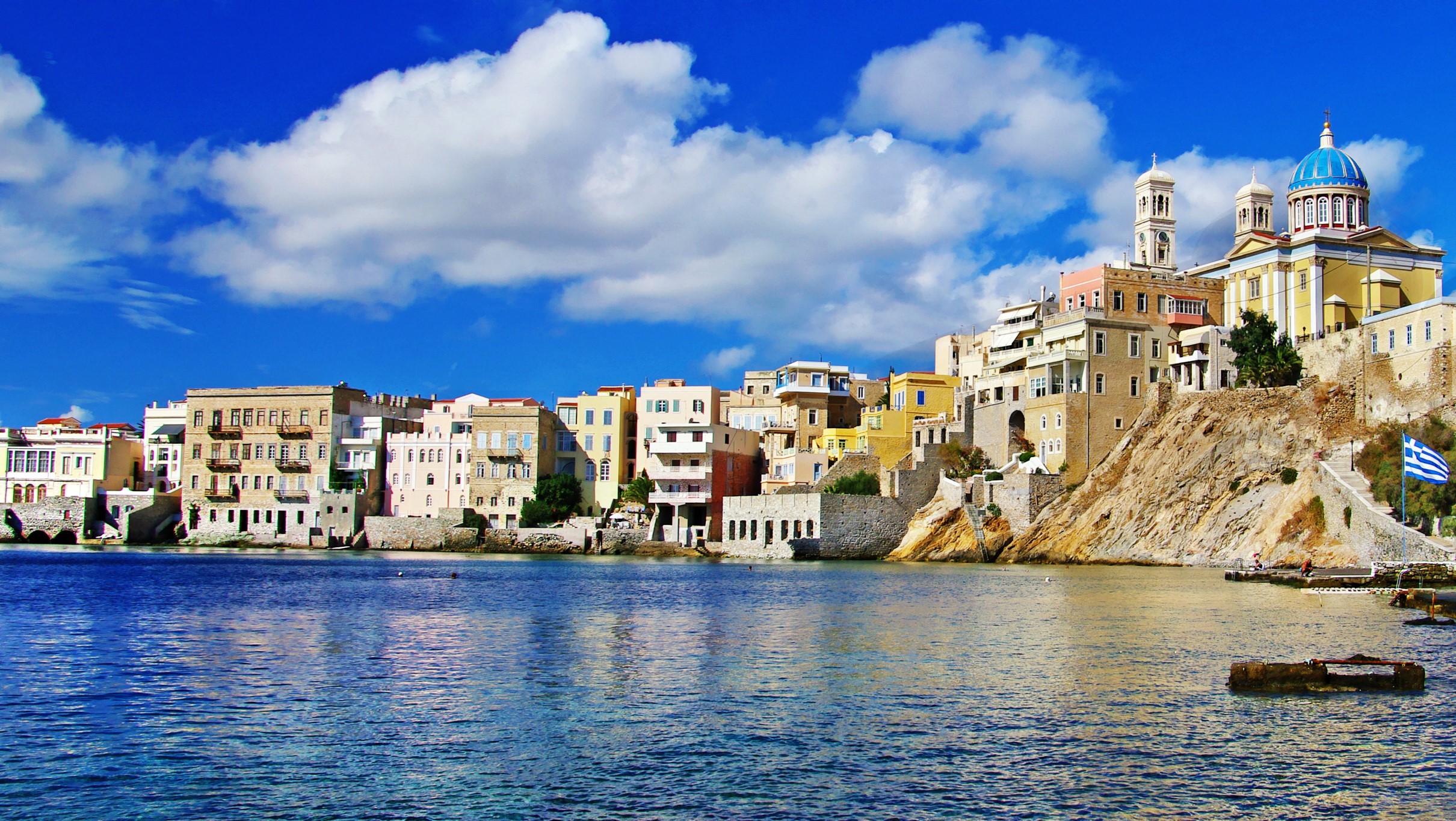 Colorful buildings on a hill overlooking the sea in Greece HD Wallpaper