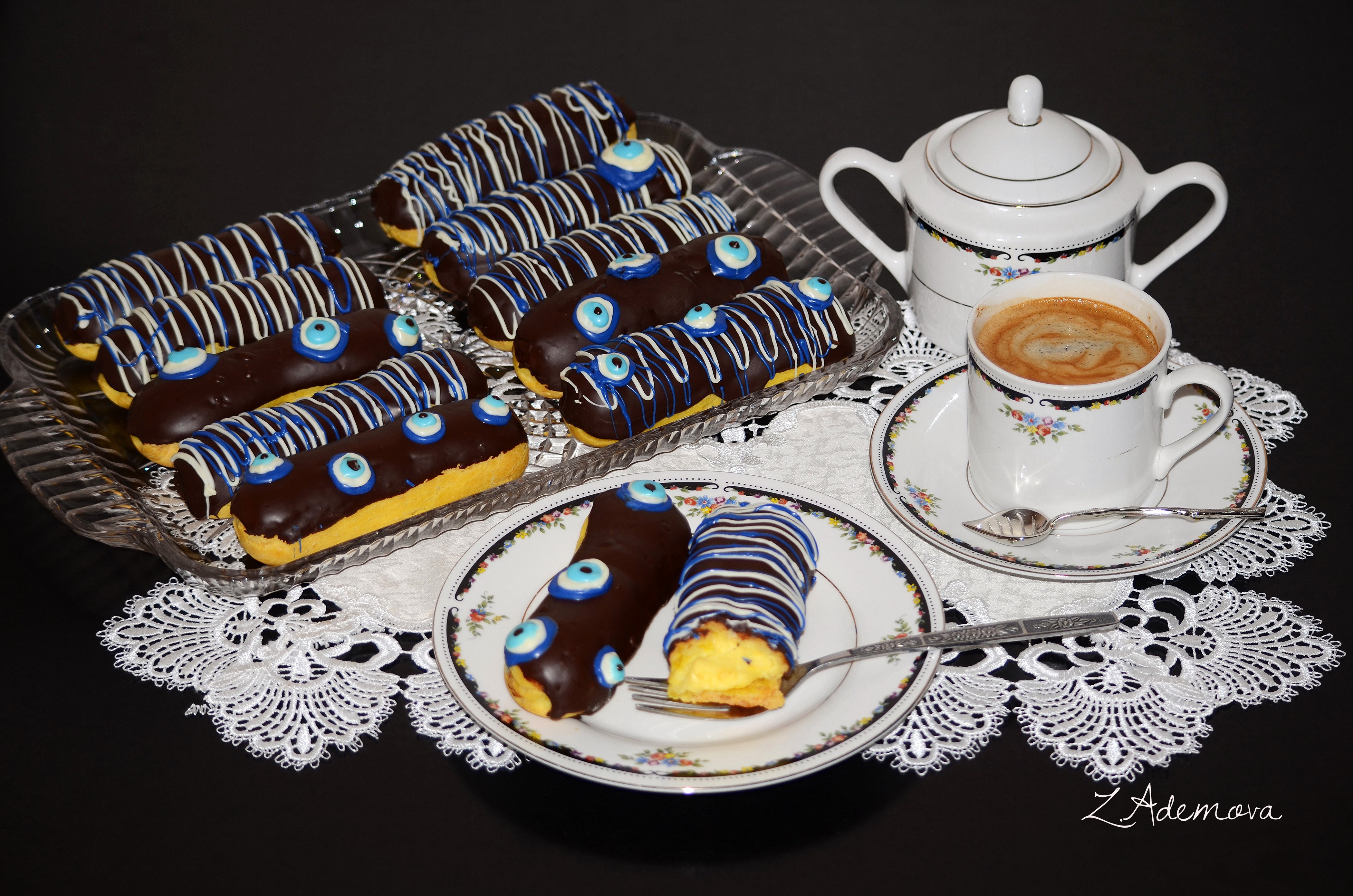 Chocolate eclairs with evil eye decoration and coffee HD Wallpaper