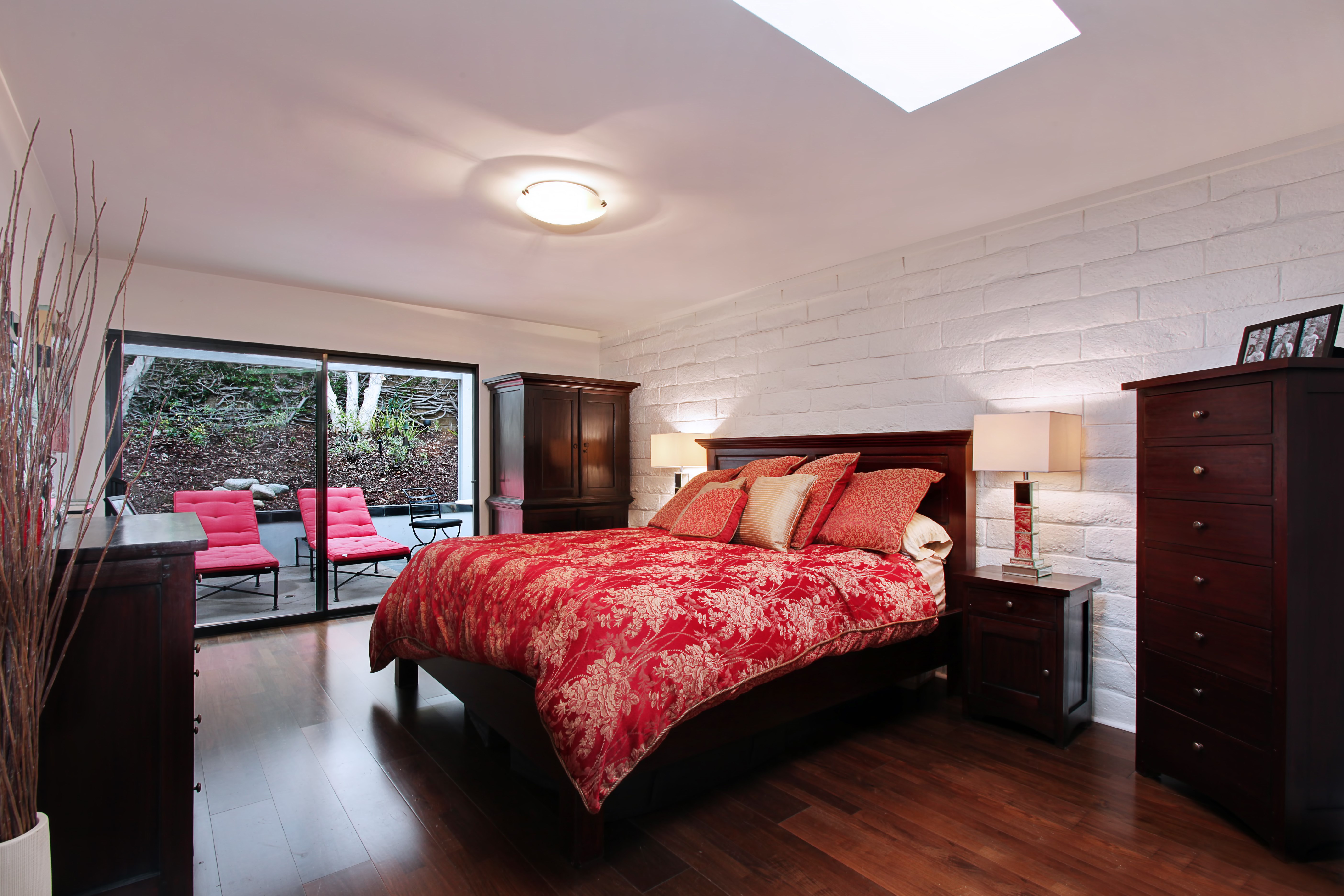 Bedroom with red bedding and patio access HD Wallpaper