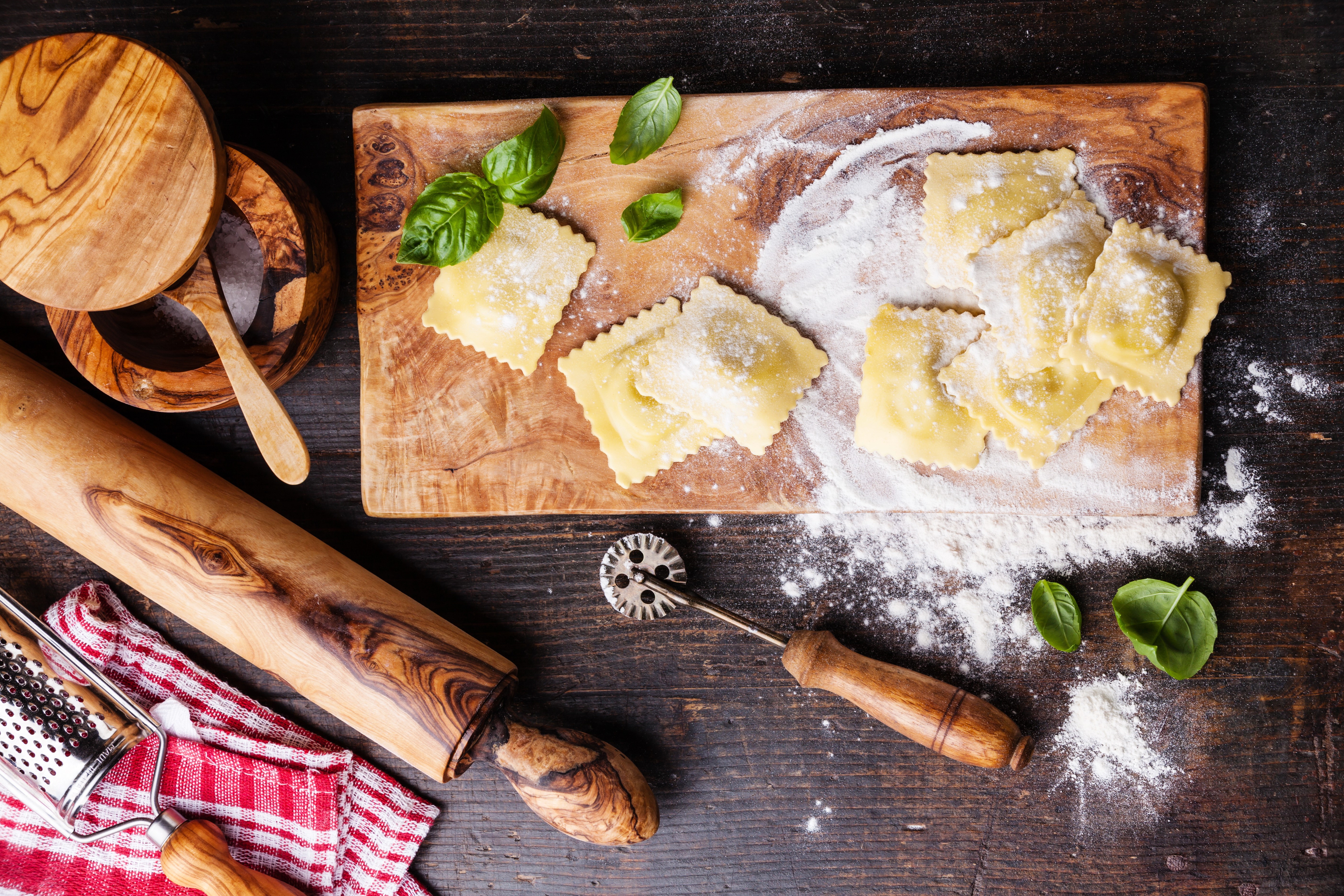 Still-life of fresh ravioli with basil and cooking utensils HD Wallpaper