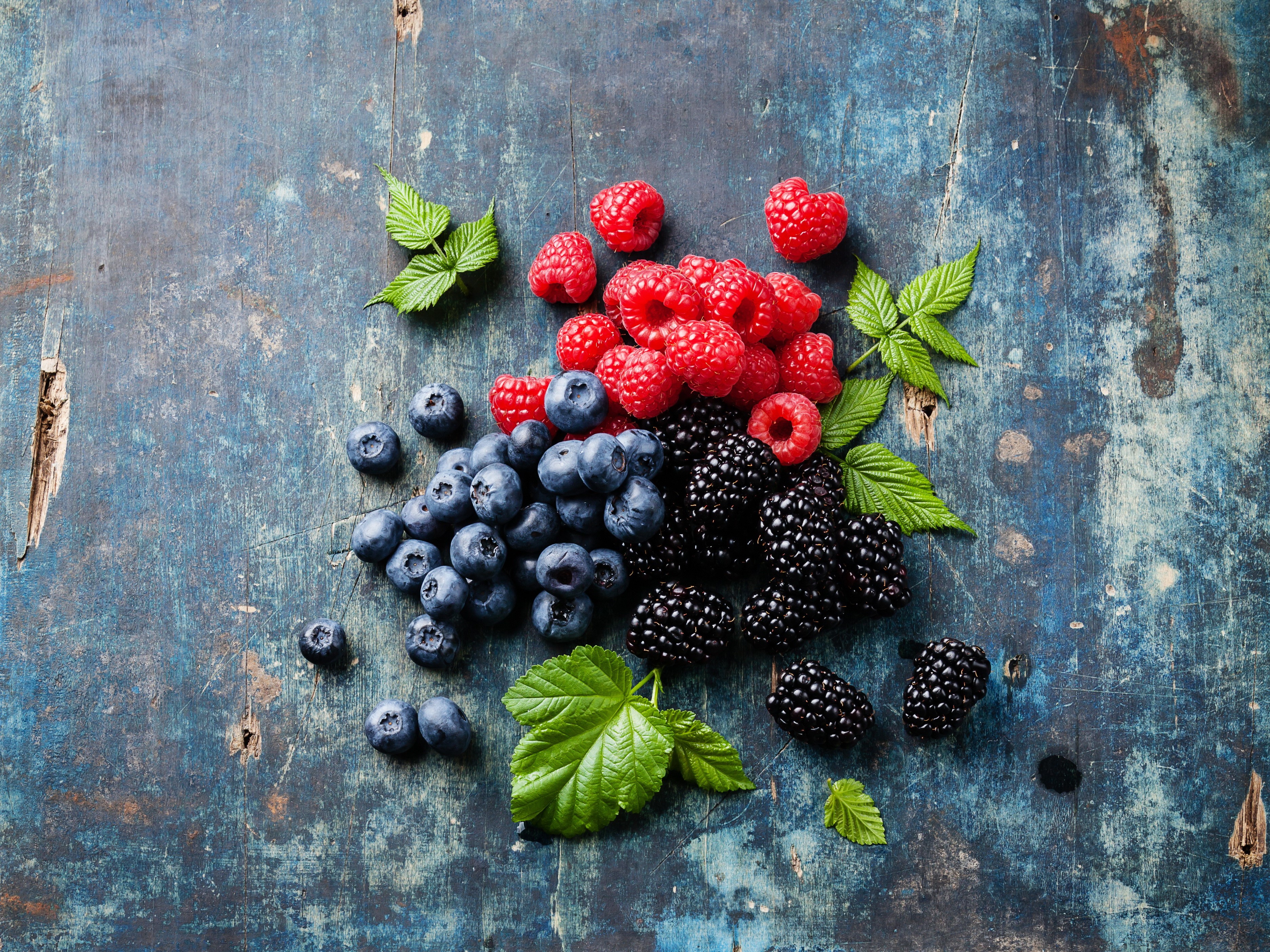 Raspberries, Blackberries, and Blueberries on a Blue Surface HD Wallpaper