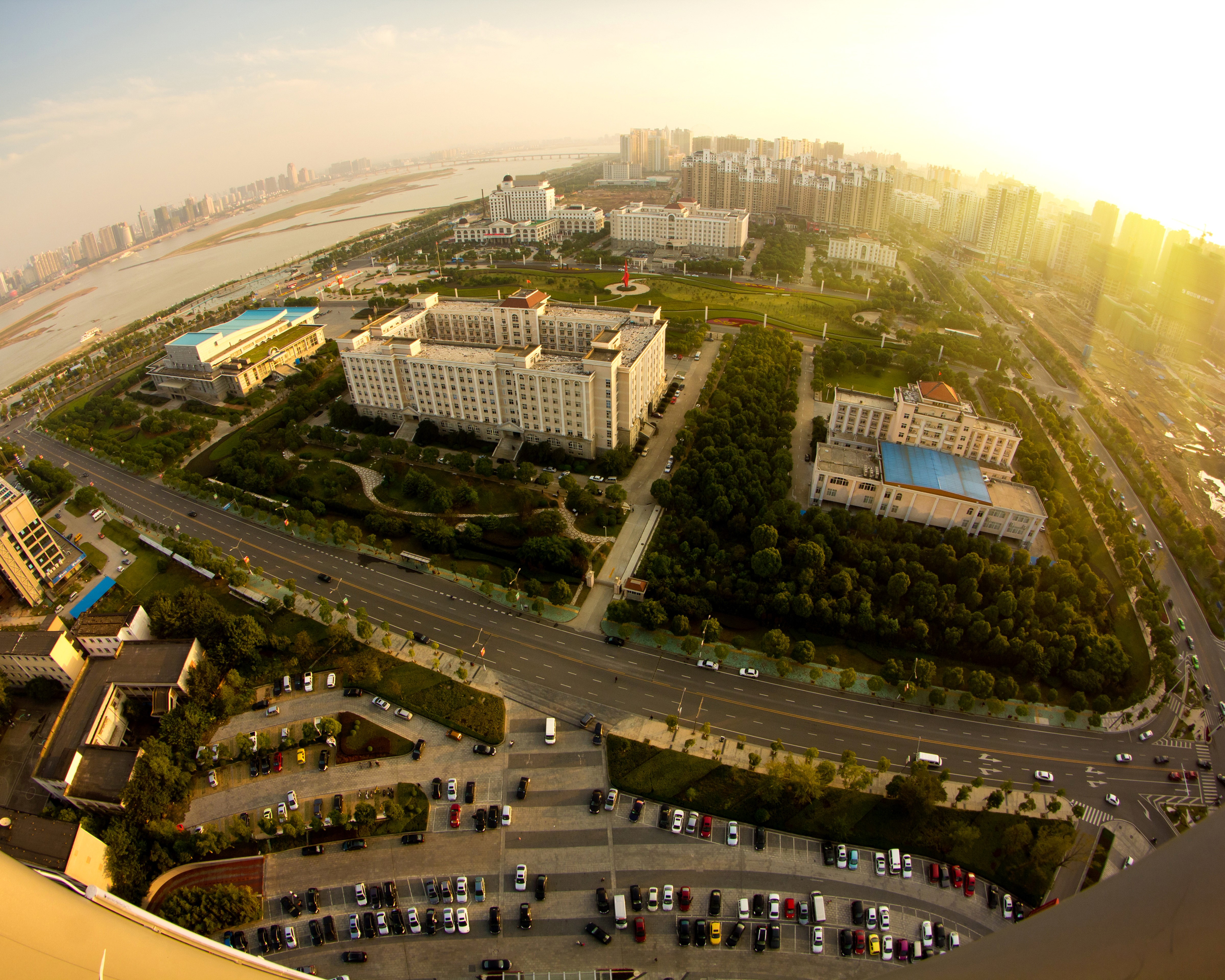 Aerial view of a city with a river and buildings HD Wallpaper