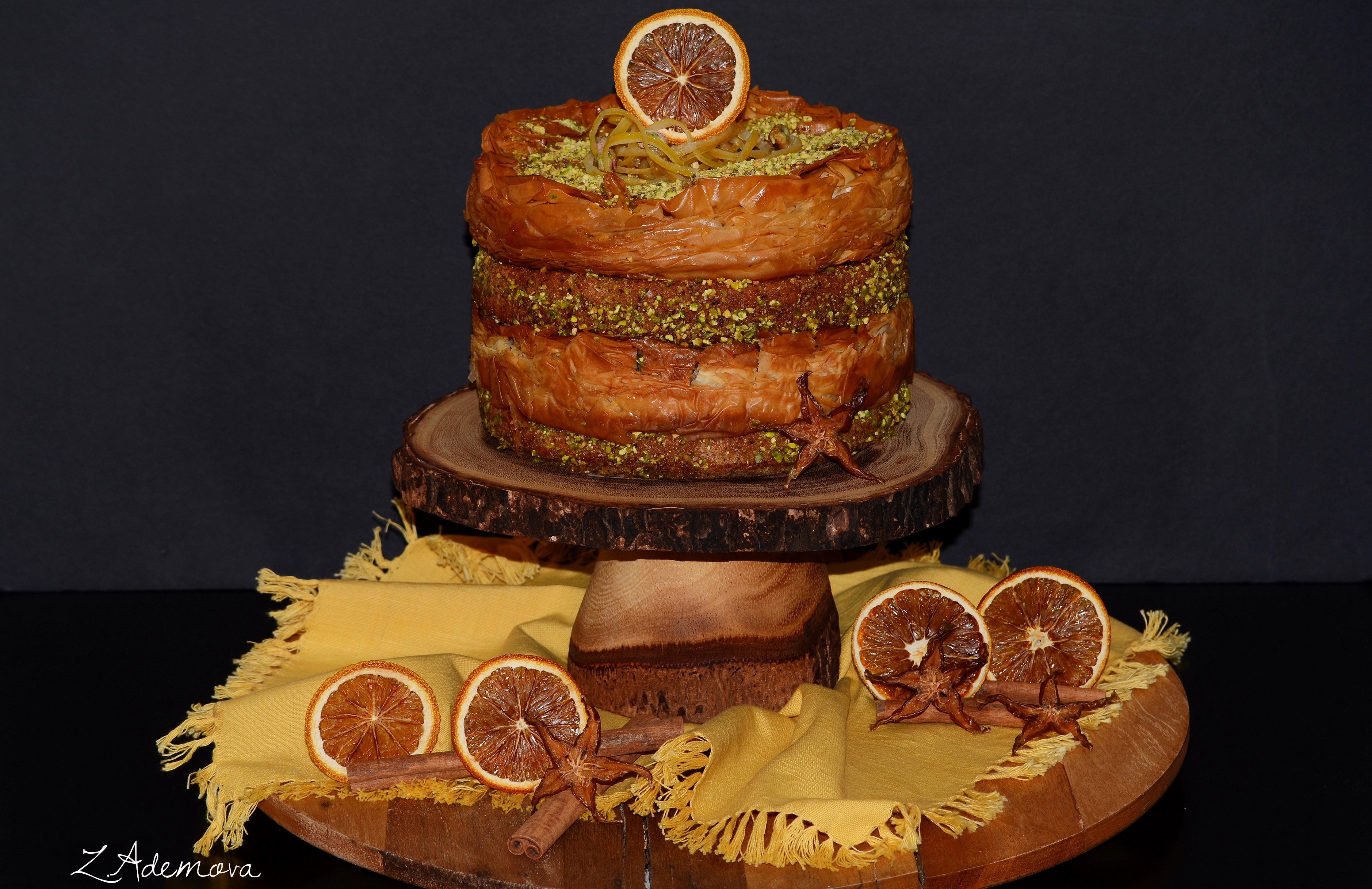 Layered baklava cake with pistachios and orange slice HD Wallpaper