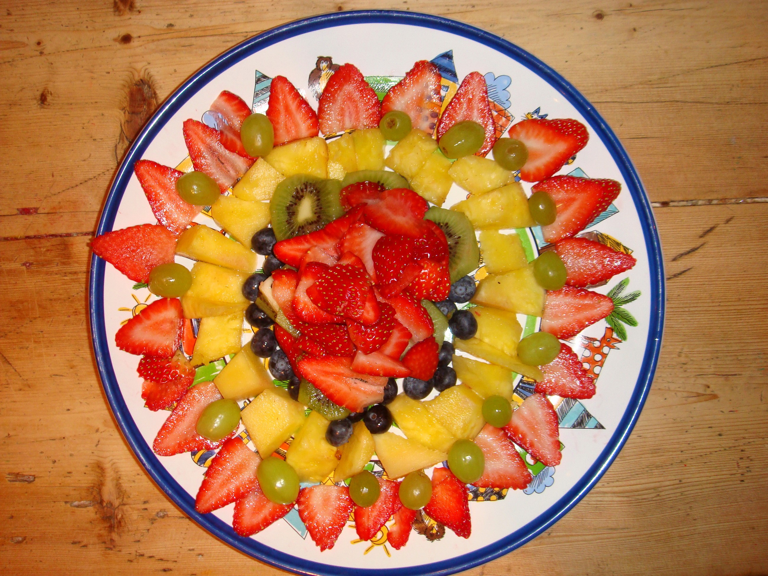 Fruit platter with strawberries, kiwi, blueberries, and grapes HD Wallpaper