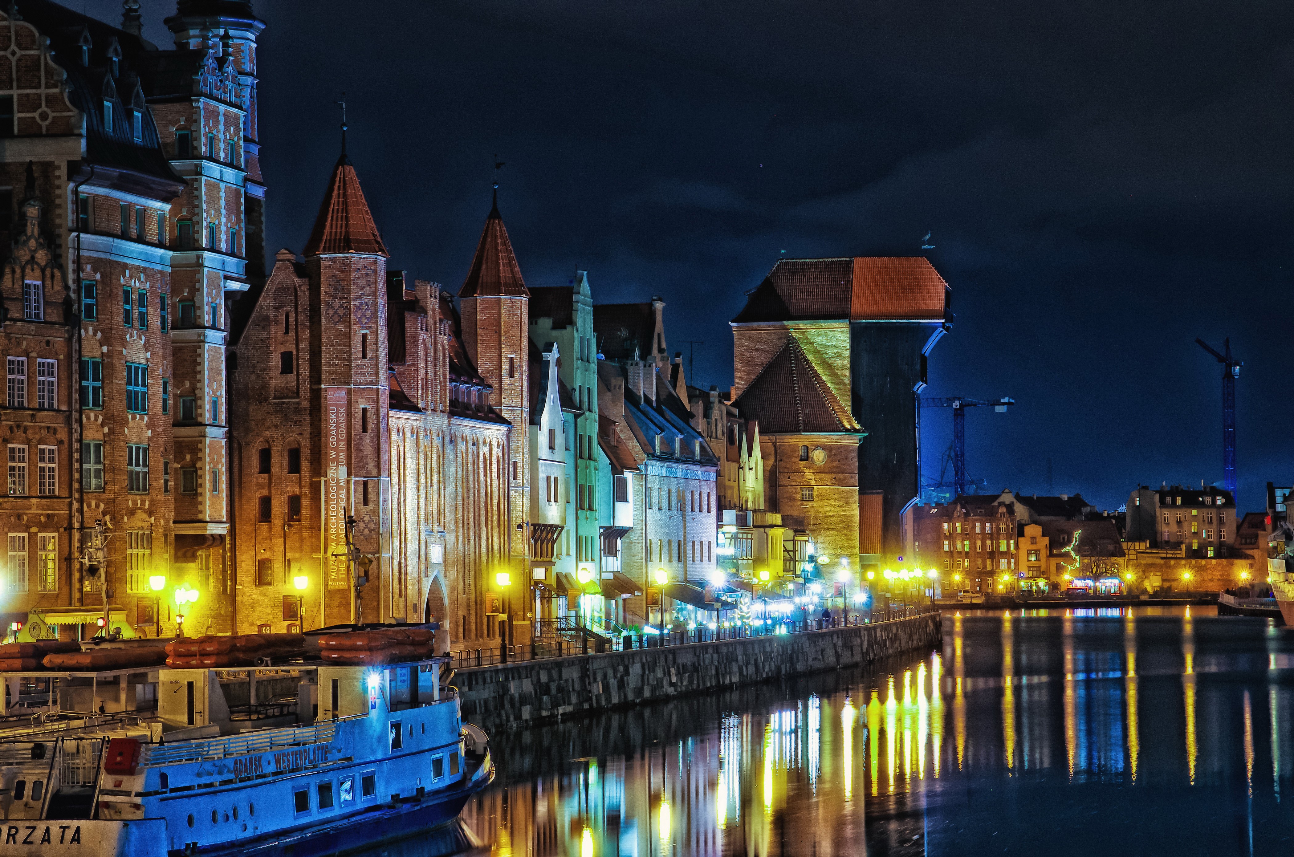 4K Night view of Gdańsk waterfront with historic buildings and river HD Wallpaper