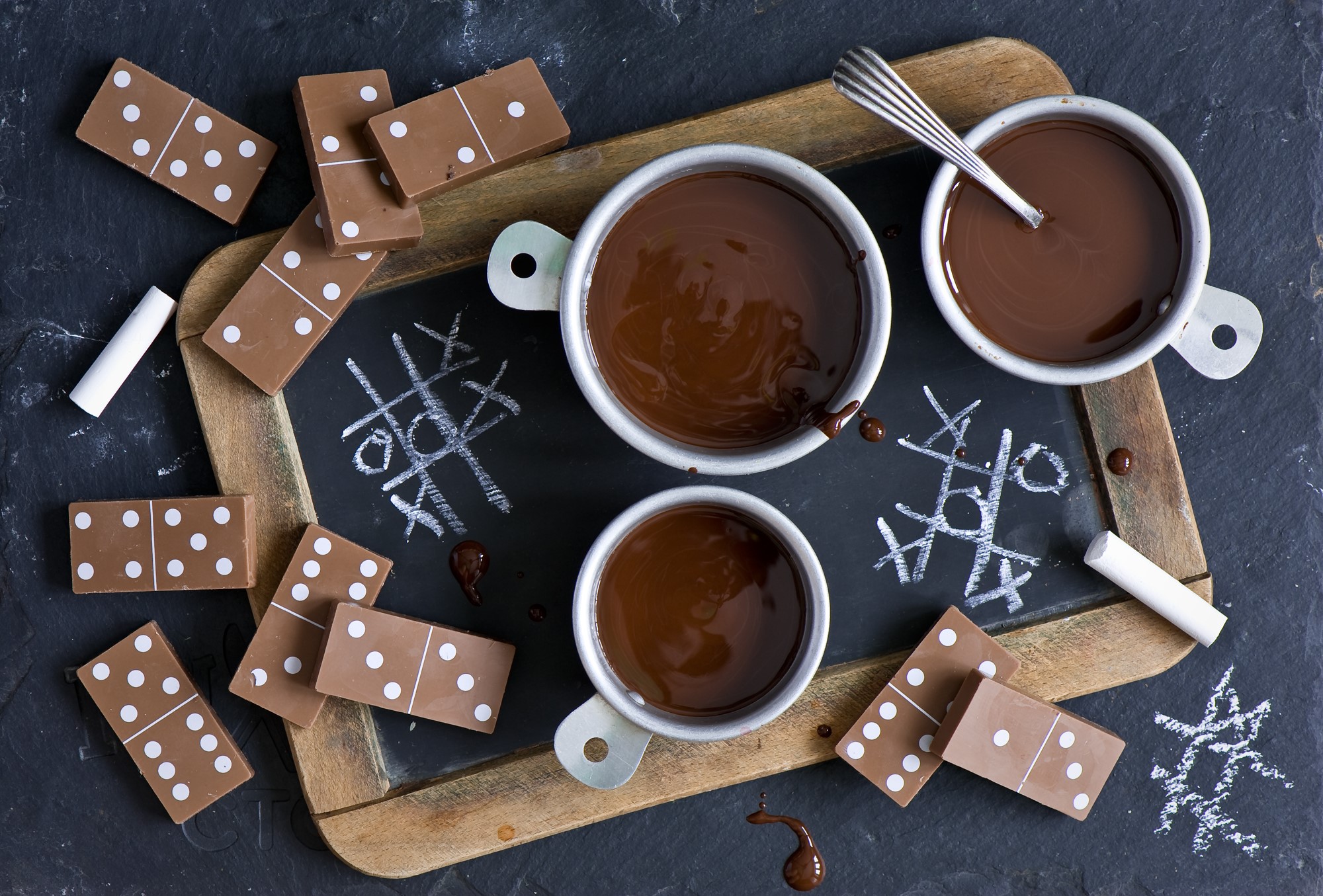 Chocolate dominoes and hot chocolate on a chalkboard HD Wallpaper