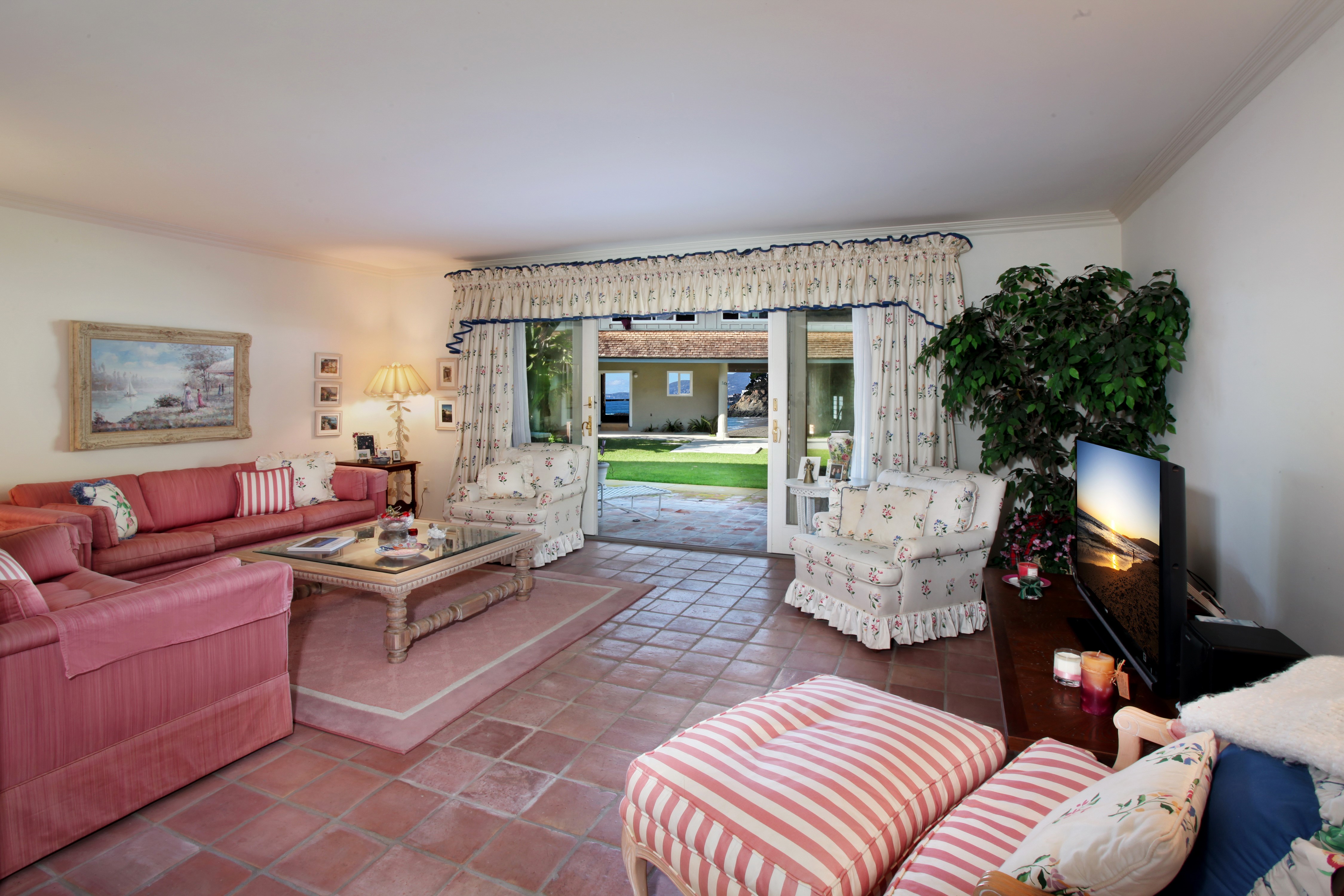 Living room with sofa and view of backyard HD Wallpaper