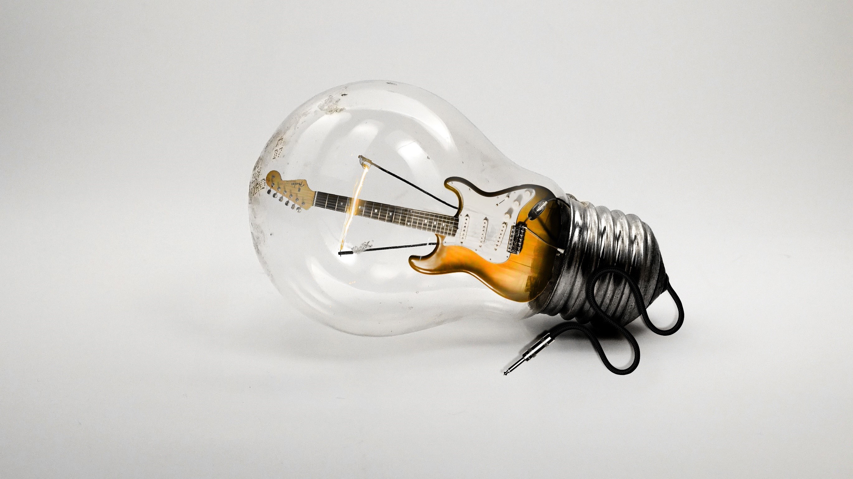 Guitar inside a light bulb HD Wallpaper