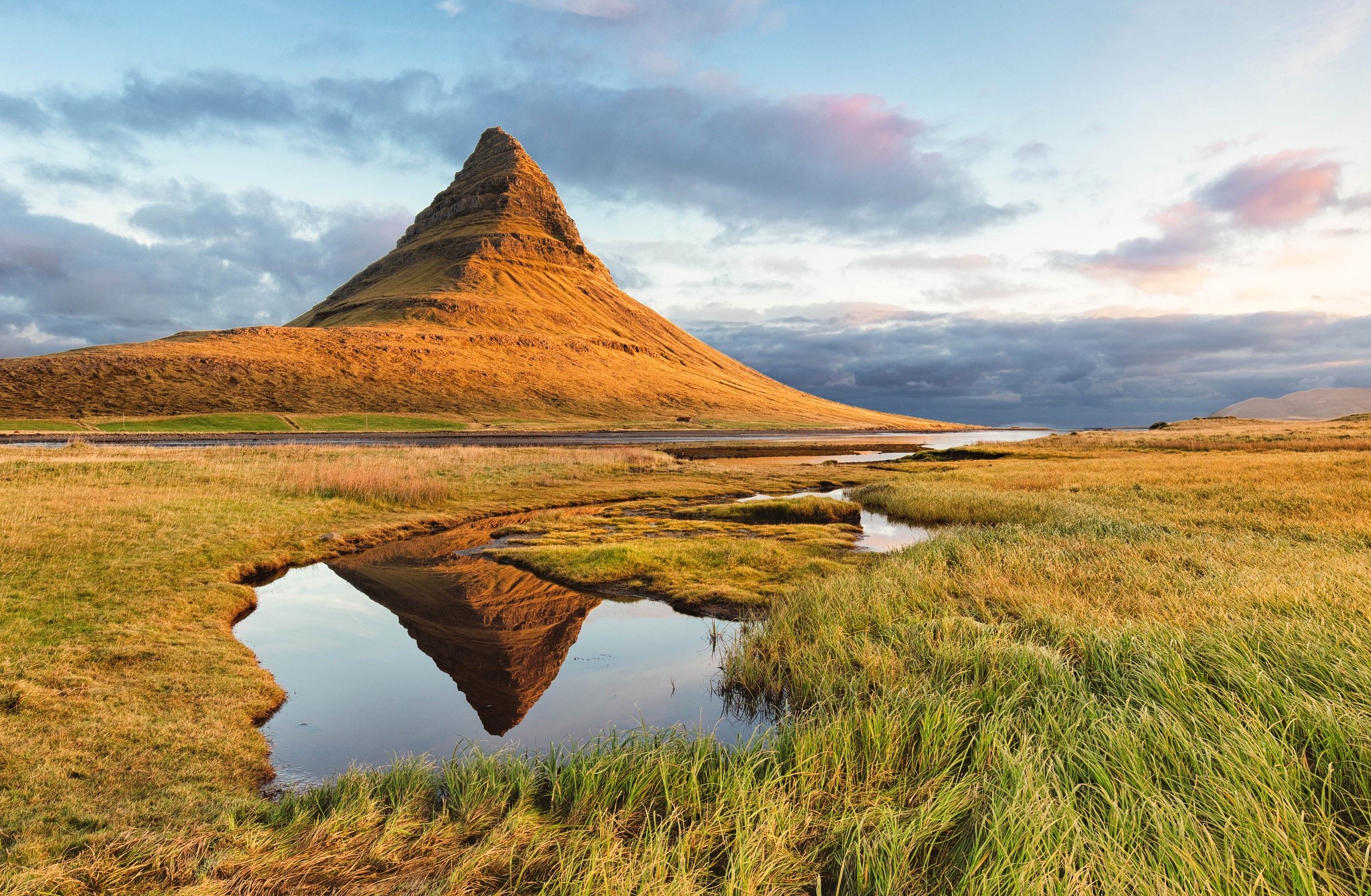 Kirkjufell mountain reflected in a stream under clouds HD Wallpaper