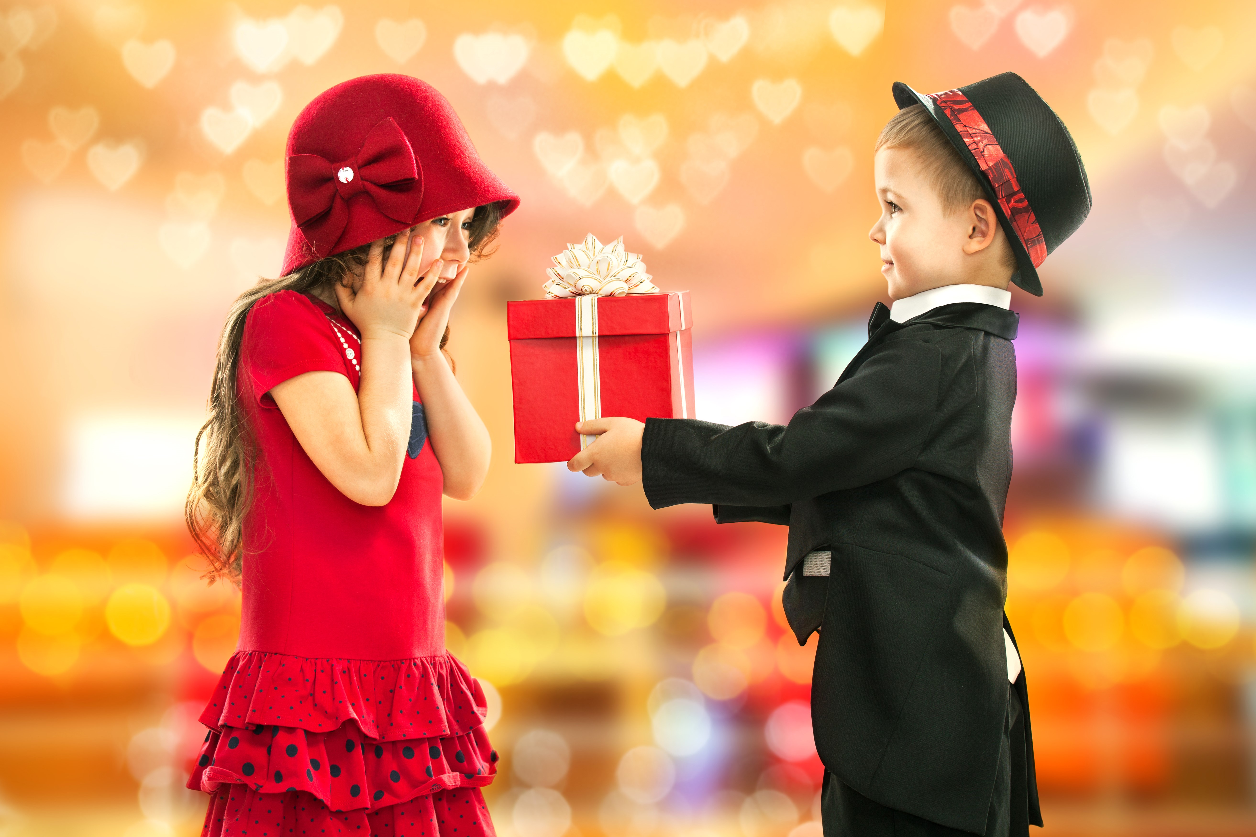 Boy in Suit Gives Gift to Girl in Red Dress HD Wallpaper