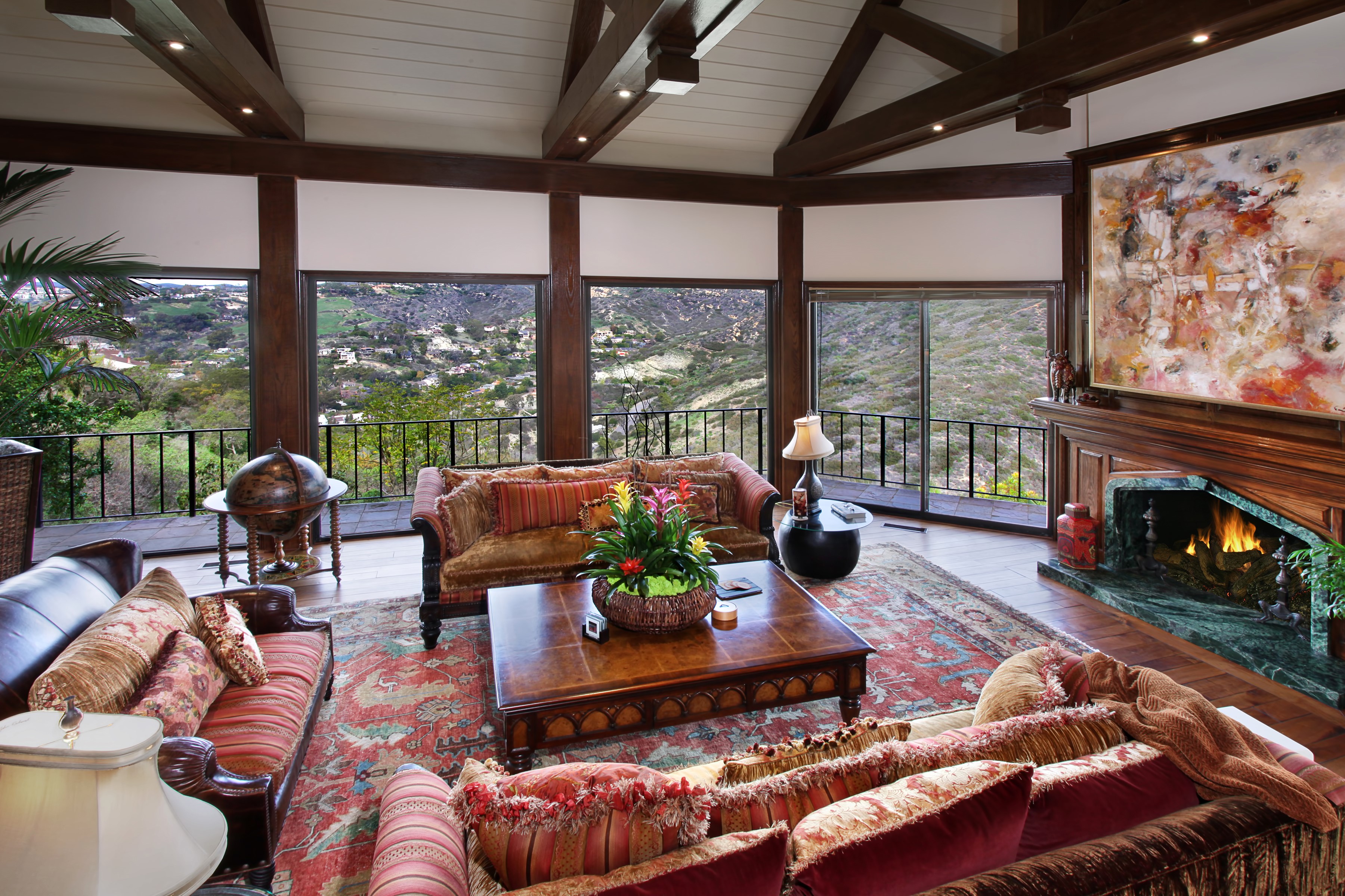 Living room with fireplace, sofas, and a view HD Wallpaper