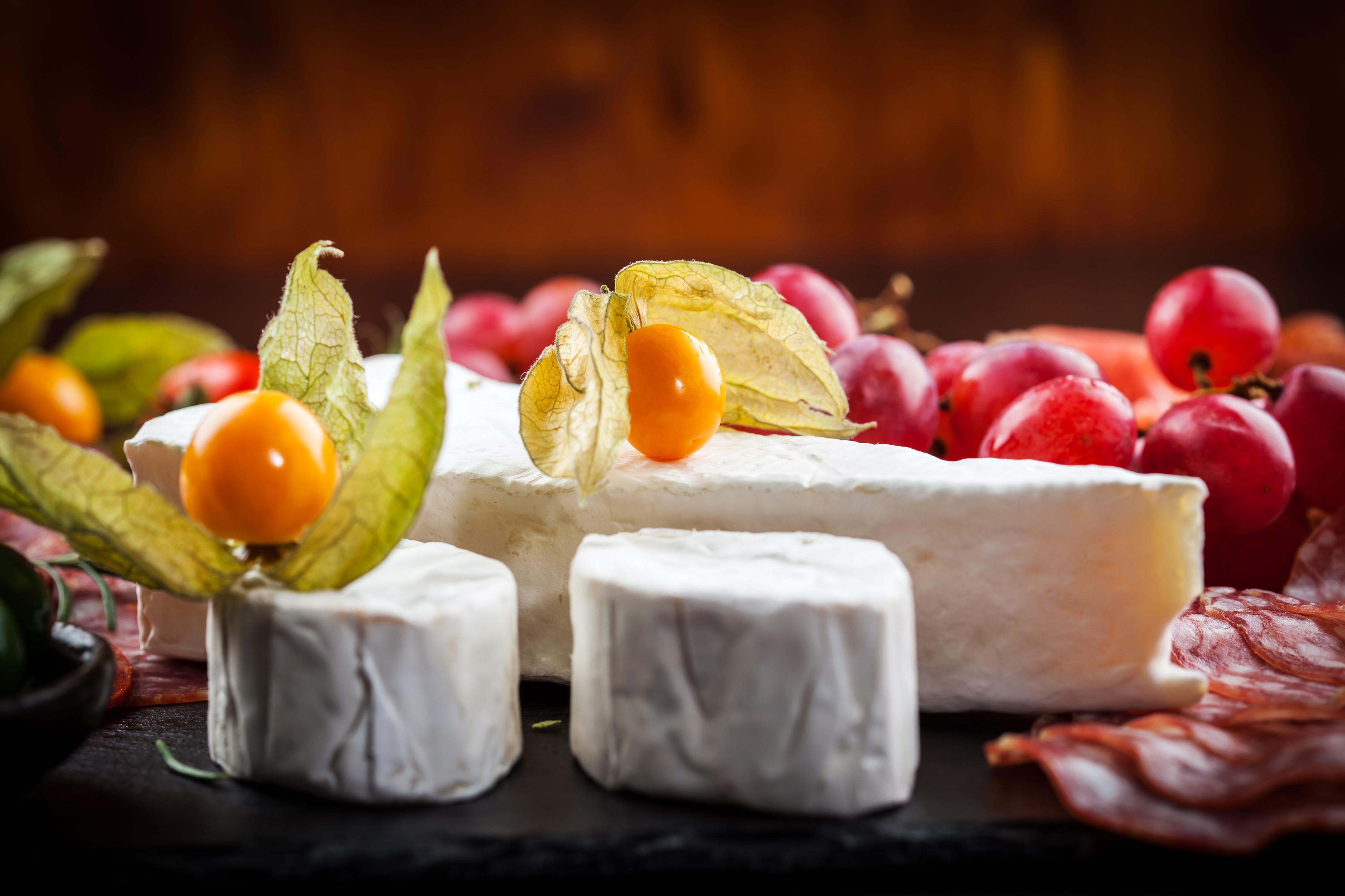 Cheese platter with grapes and physalis HD Wallpaper