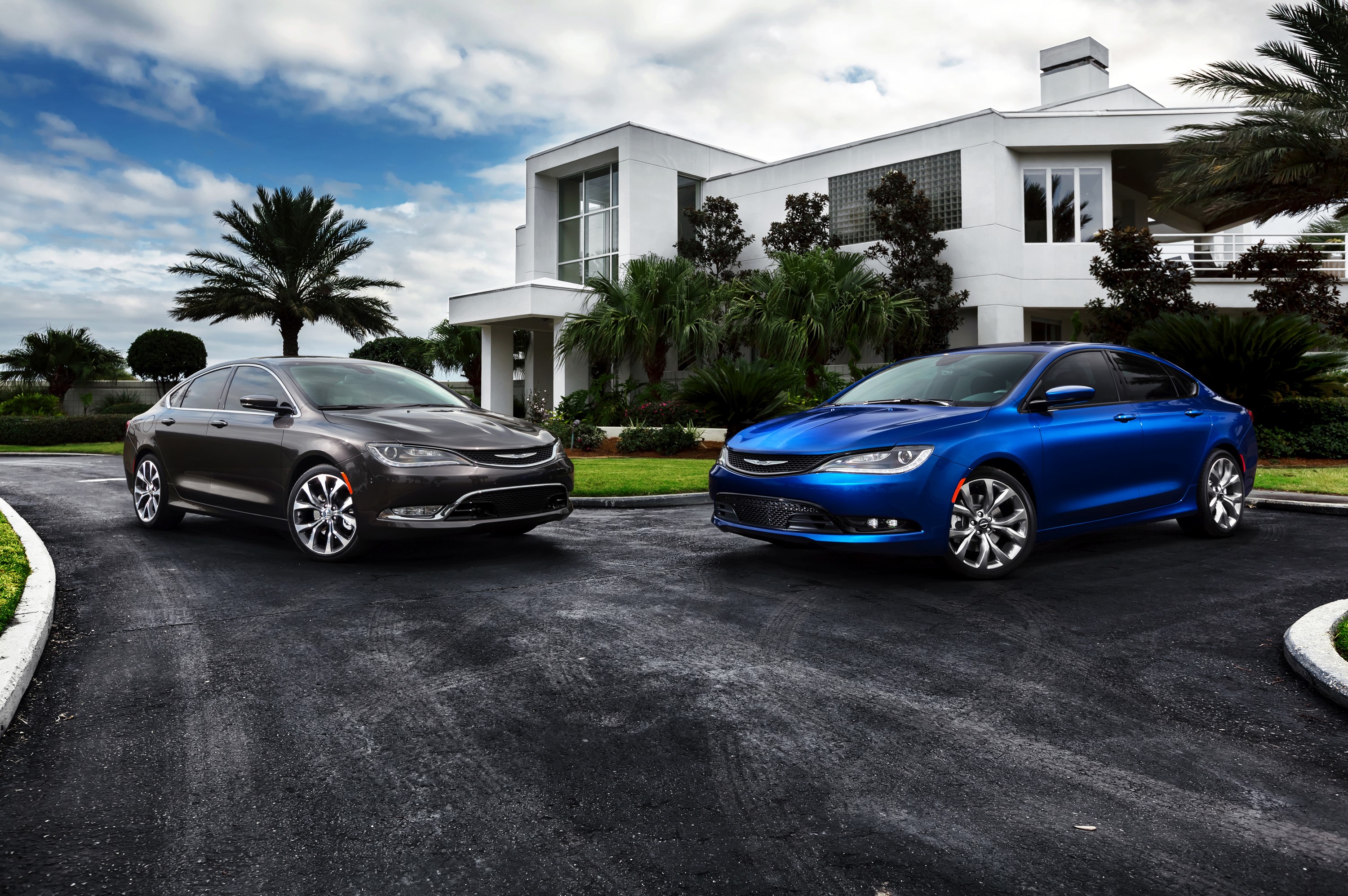 Two Chrysler 200 S sedans parked outside a modern house HD Wallpaper