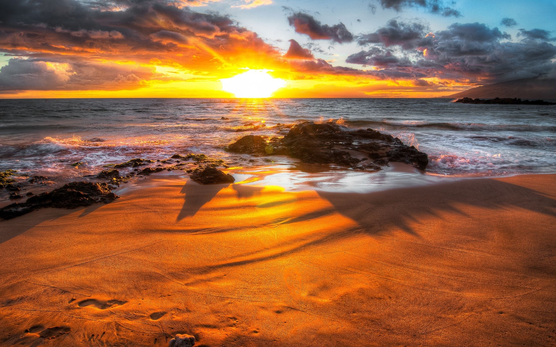 Sunset over a rocky beach with ocean waves HD Wallpaper