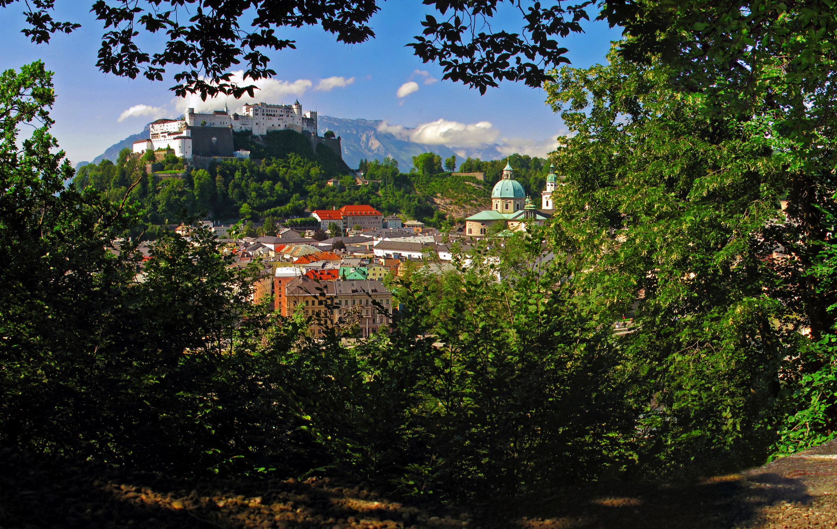 Salzburg cityscape with Hohensalzburg Fortress and church domes HD Wallpaper