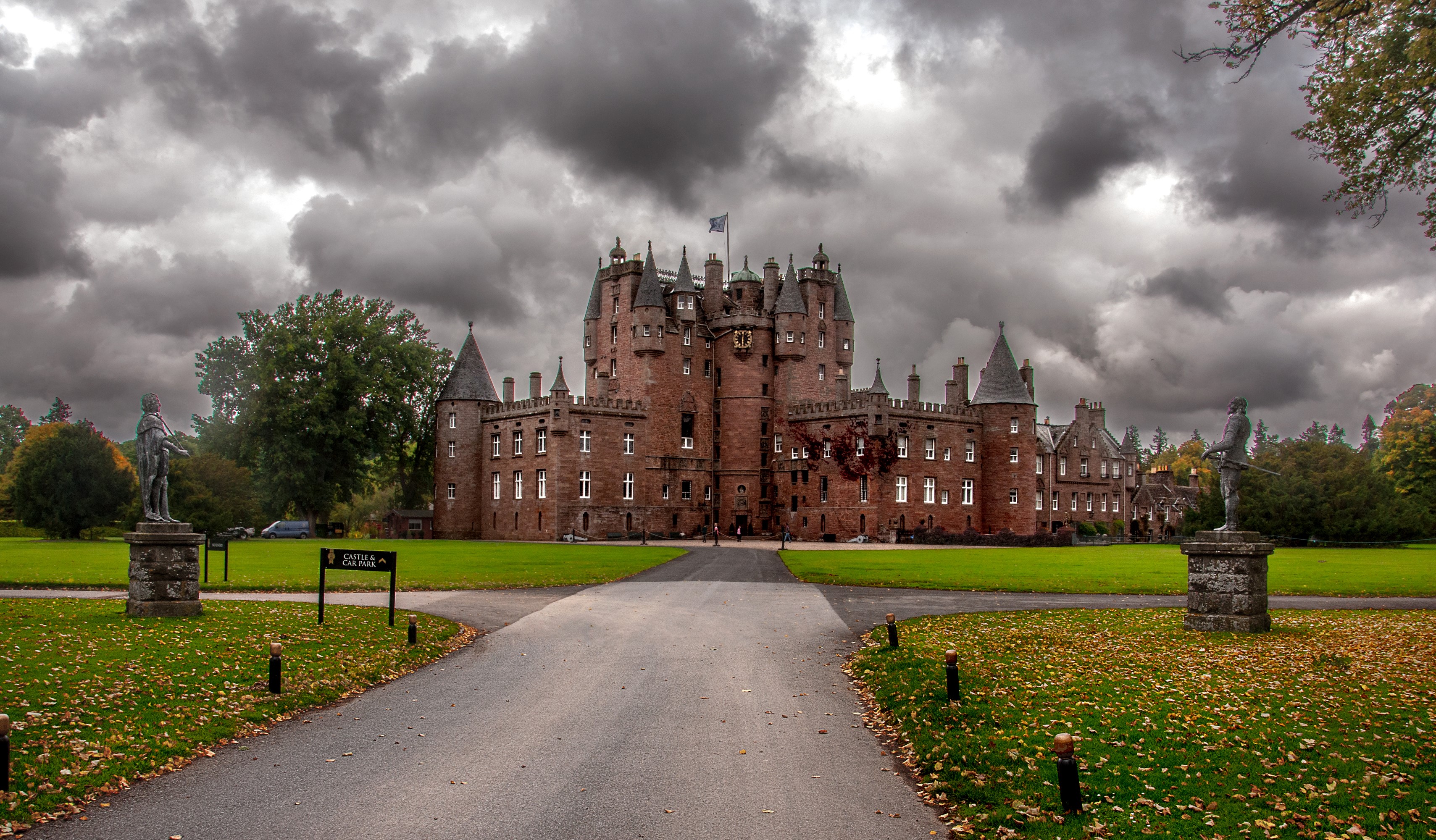 Glamis Castle in Scotland under cloudy skies HD Wallpaper