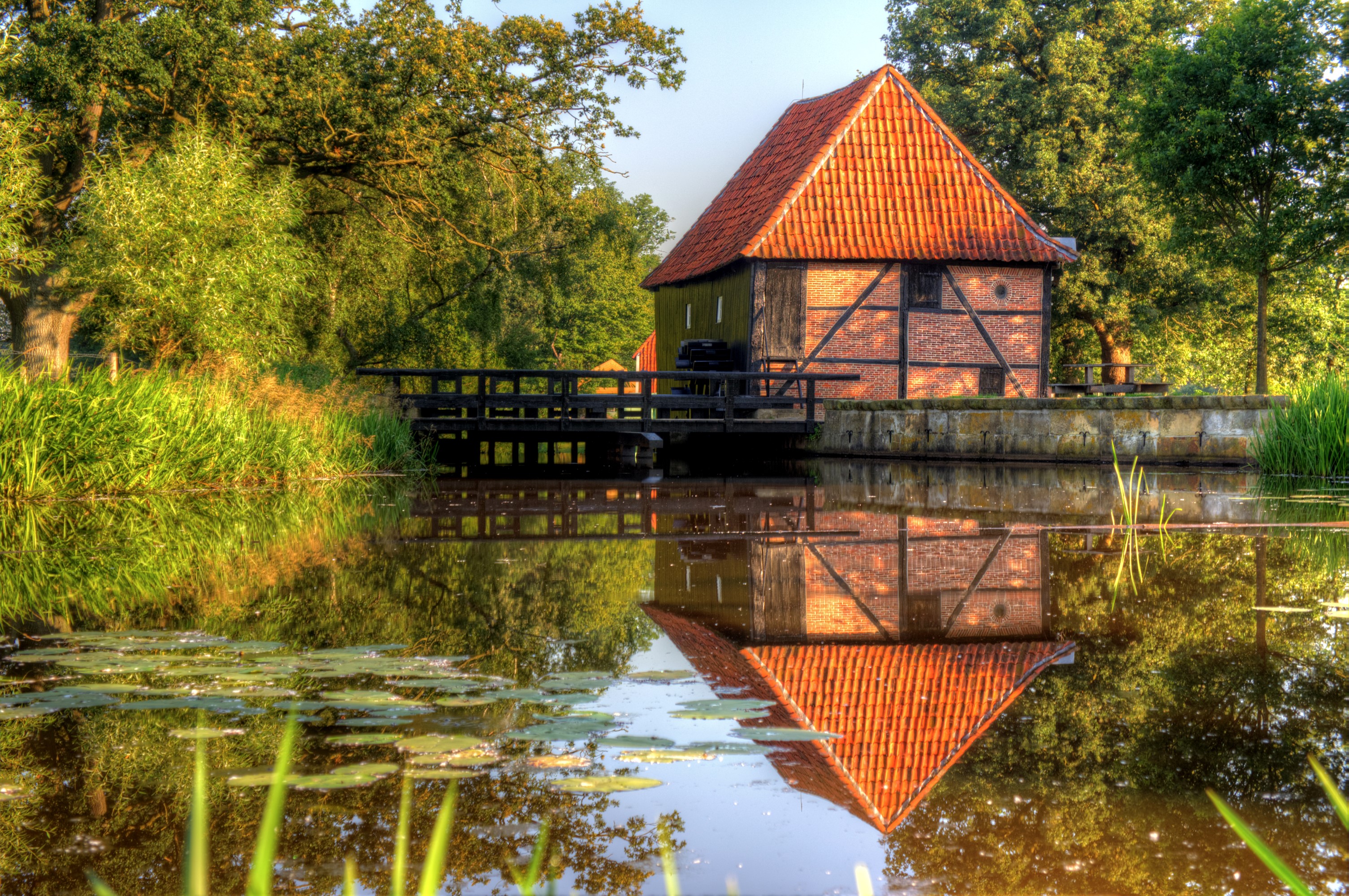 Old mill building reflected in water in Hengelo, Netherlands HD Wallpaper