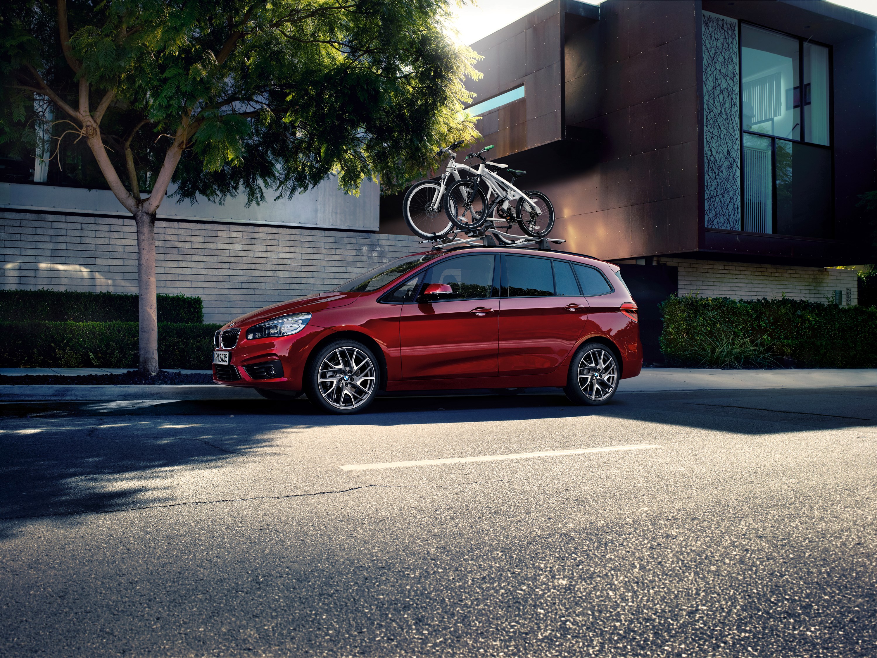 Red BMW 220i Gran Tourer with bicycles on roof rack HD Wallpaper