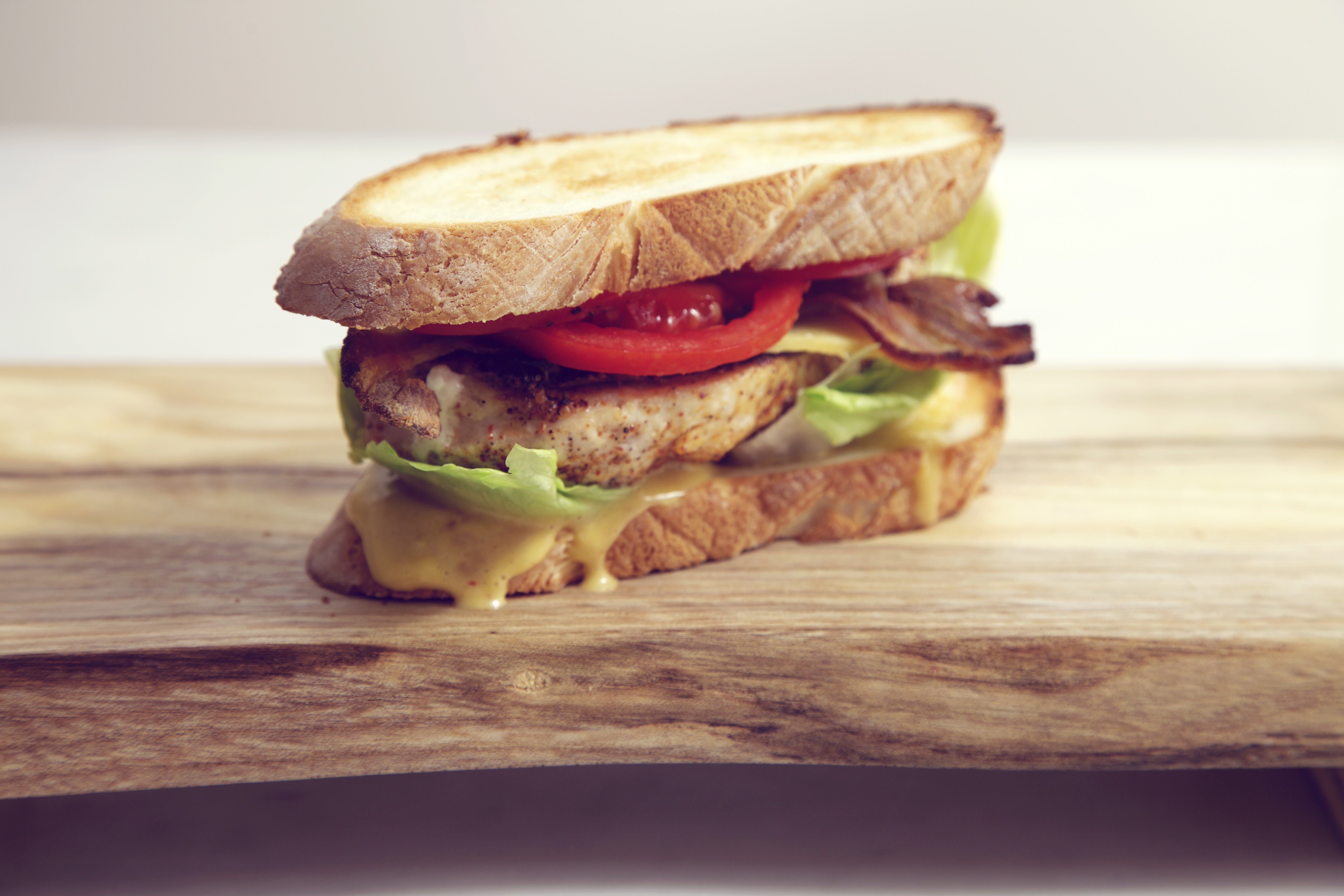 Sandwich with chicken, bacon, lettuce, tomato, and cheese HD Wallpaper