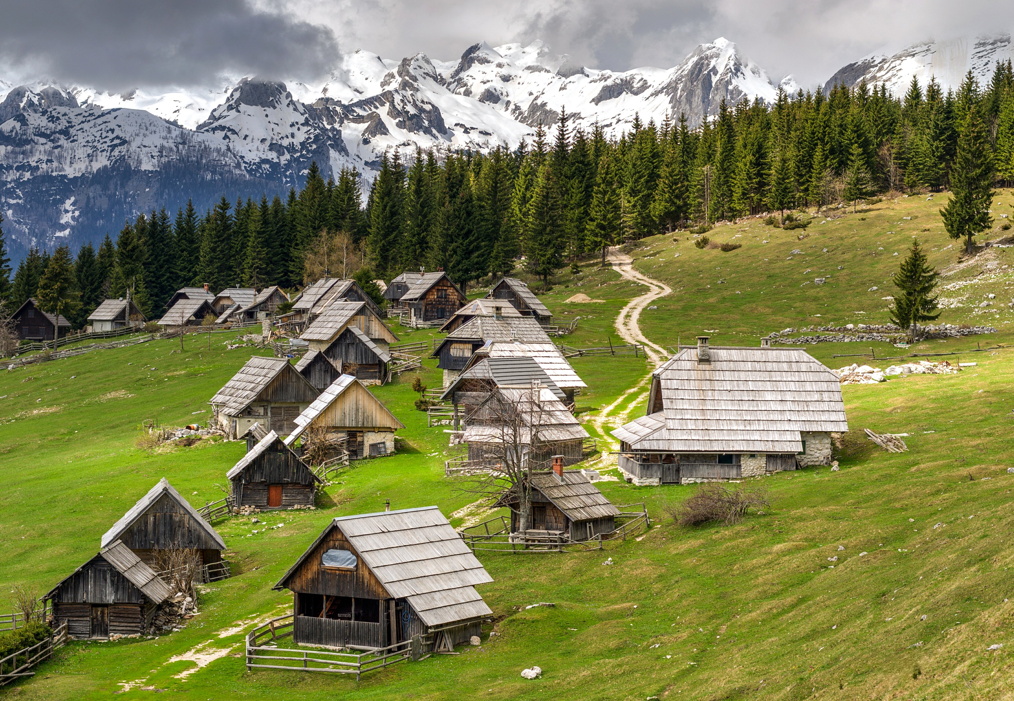 Wooden houses in a mountain village in Slovenia HD Wallpaper