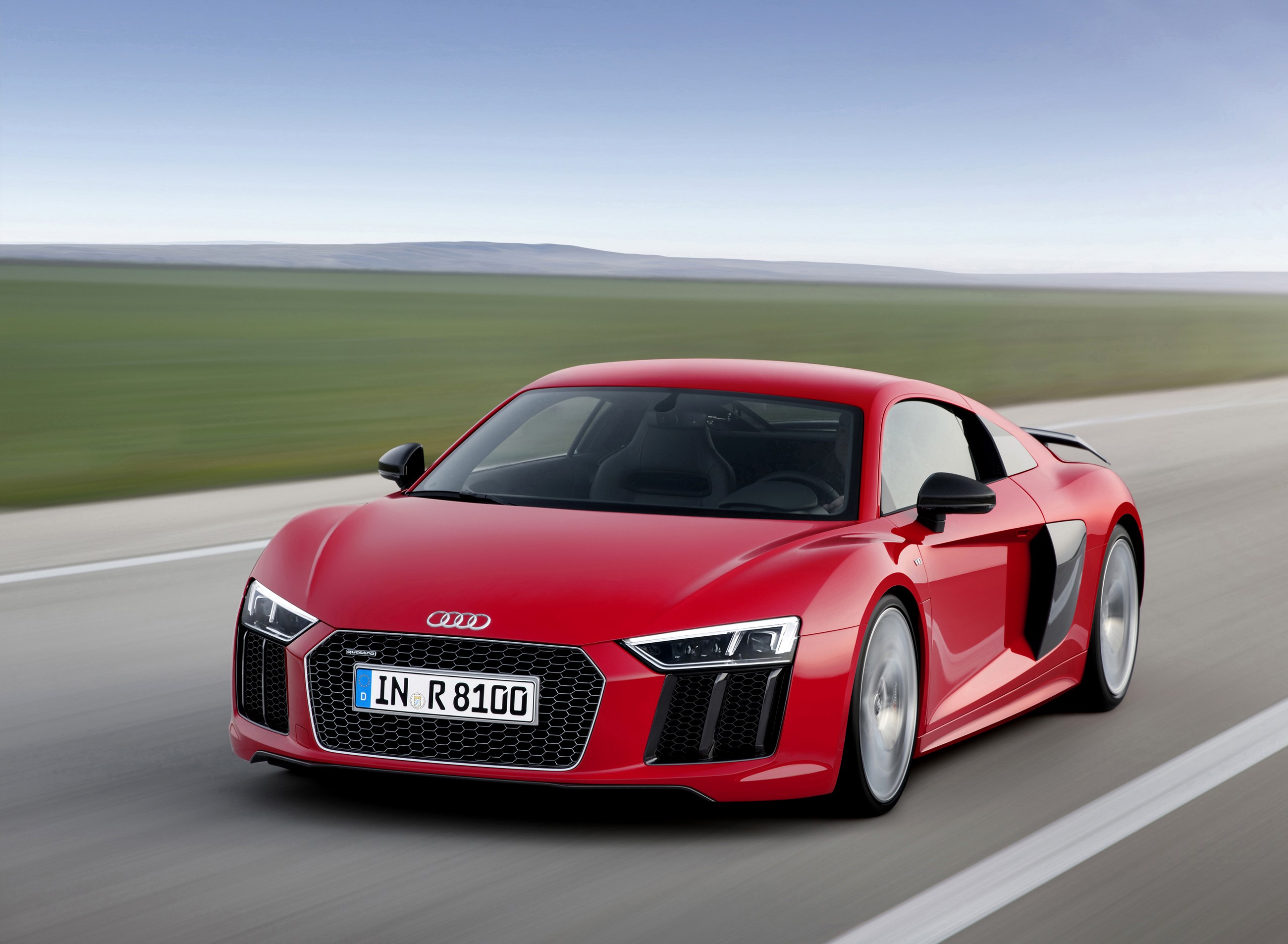 Red Audi R8 V10 plus driving on a road HD Wallpaper