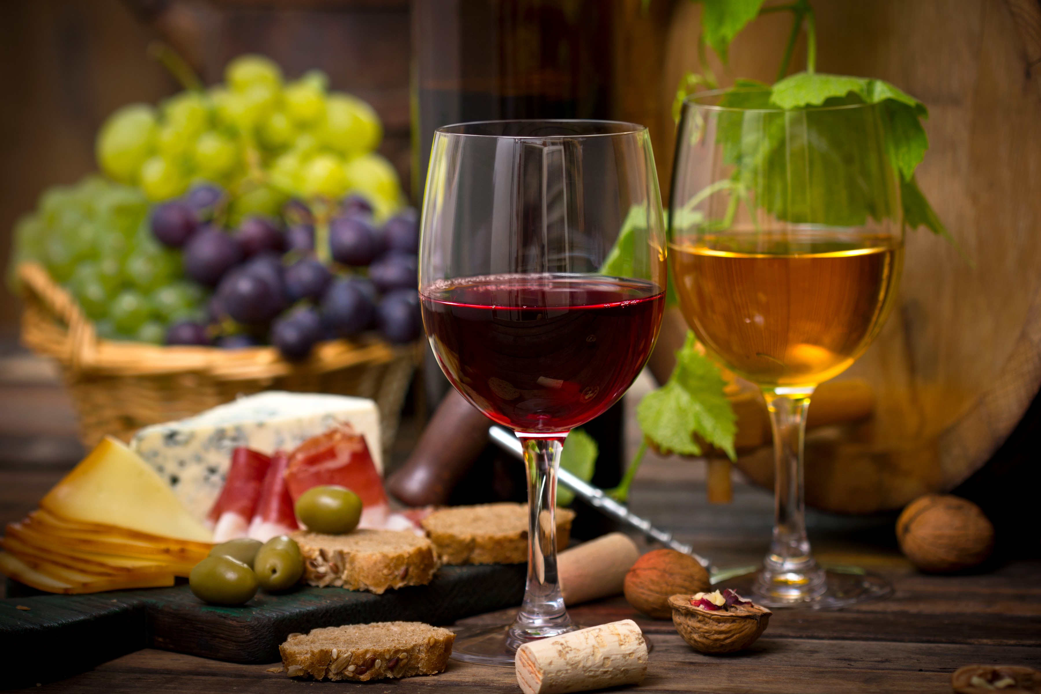 Still-life with red and white wine, grapes, cheese, nuts, and bread HD Wallpaper