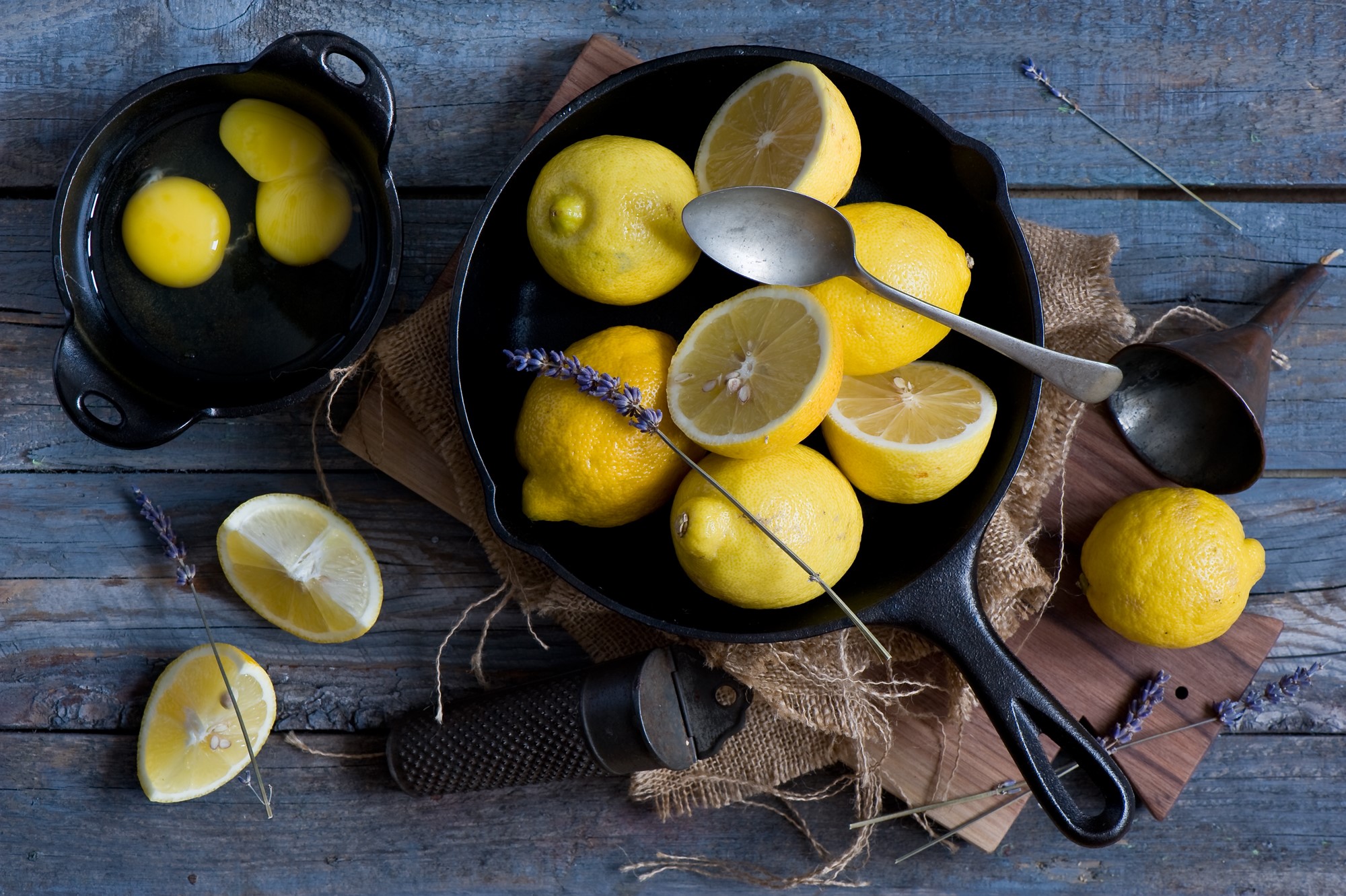 Lemons and eggs in cast iron pans with lavender HD Wallpaper