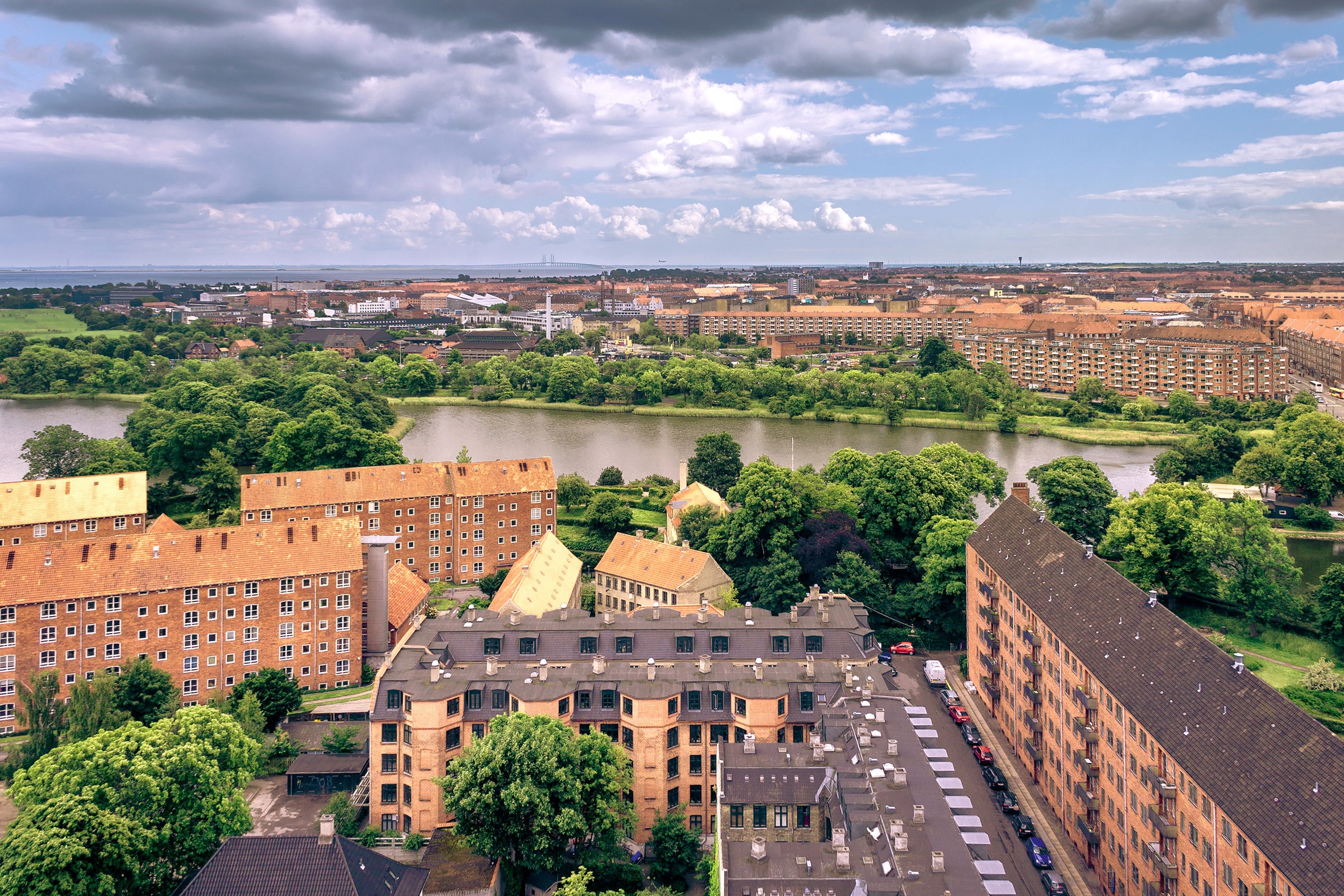 Aerial view of Copenhagen with buildings and a lake HD Wallpaper