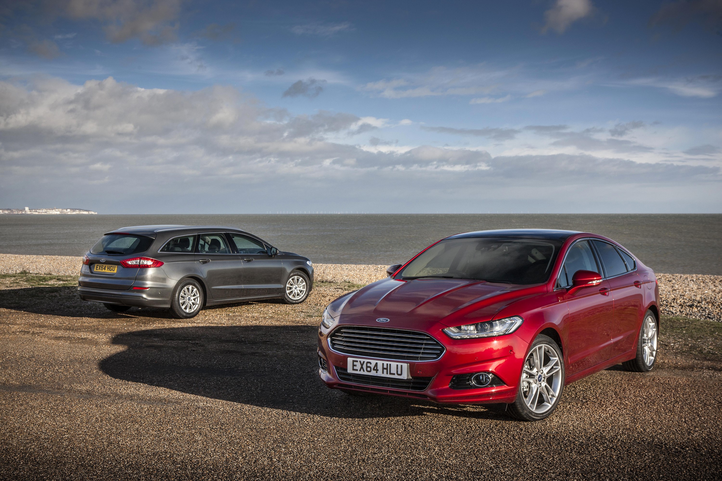 Two Ford Mondeo cars by the sea HD Wallpaper