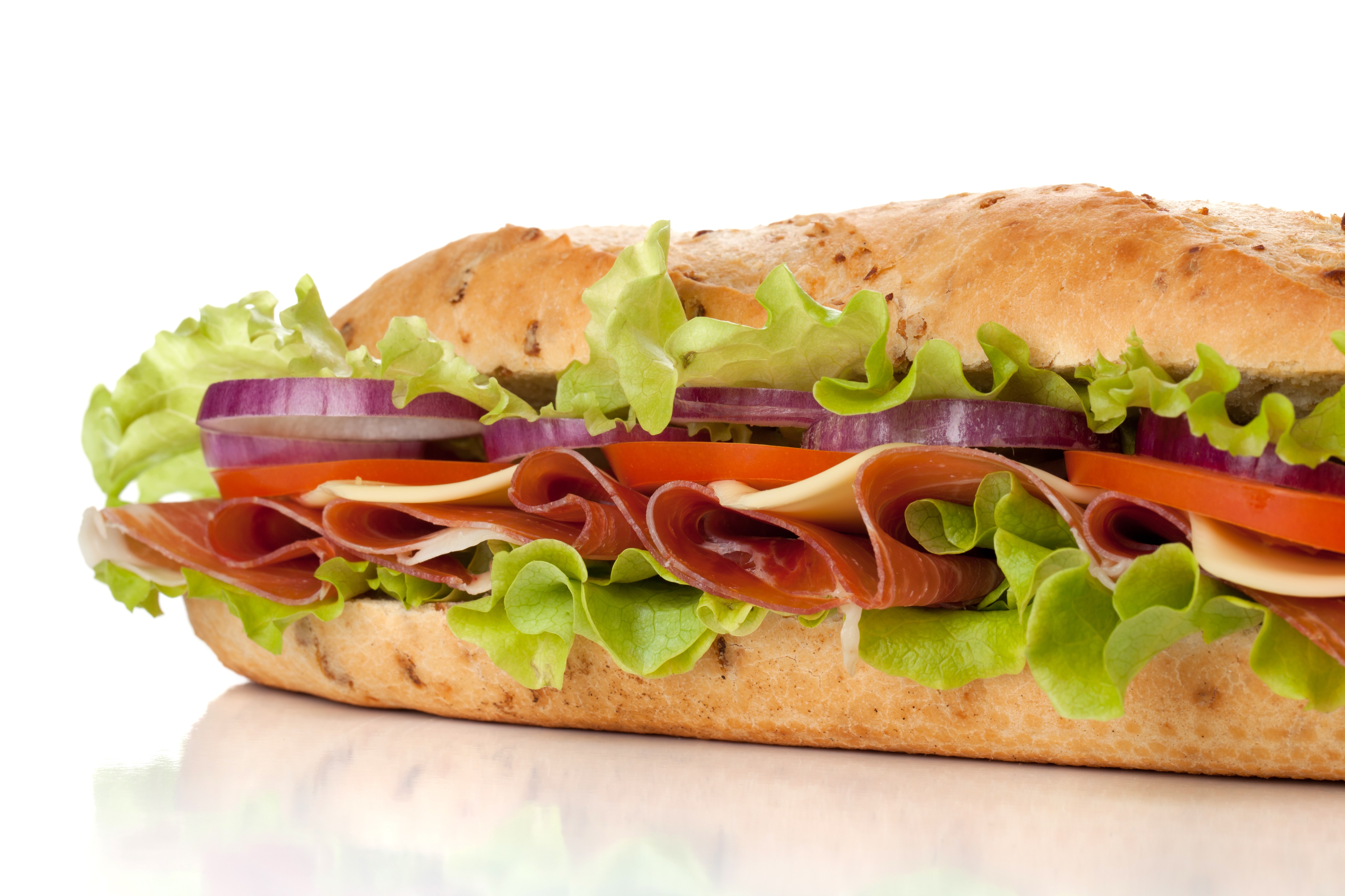 Closeup of a sandwich with ham, cheese, lettuce, tomato, and onion HD Wallpaper