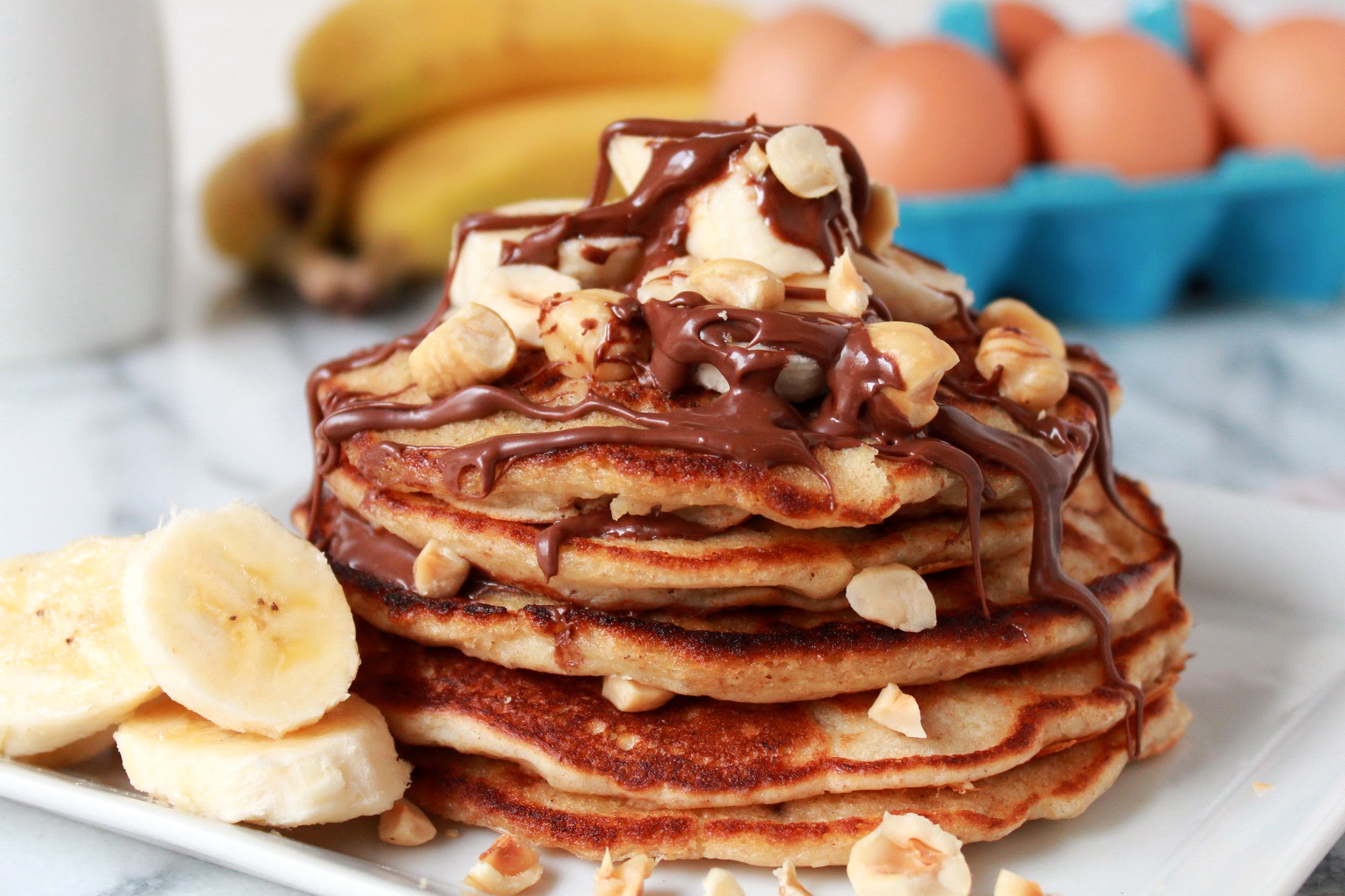 Stack of Banana Pancakes with Chocolate and Hazelnuts HD Wallpaper