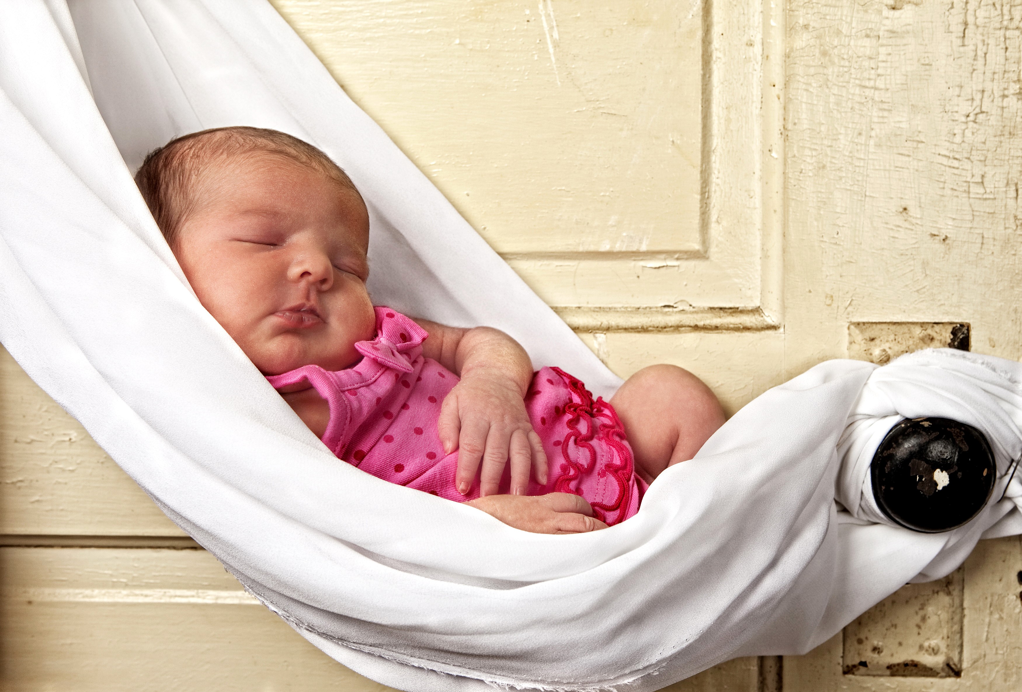 Newborn baby sleeping in a white fabric hammock HD Wallpaper