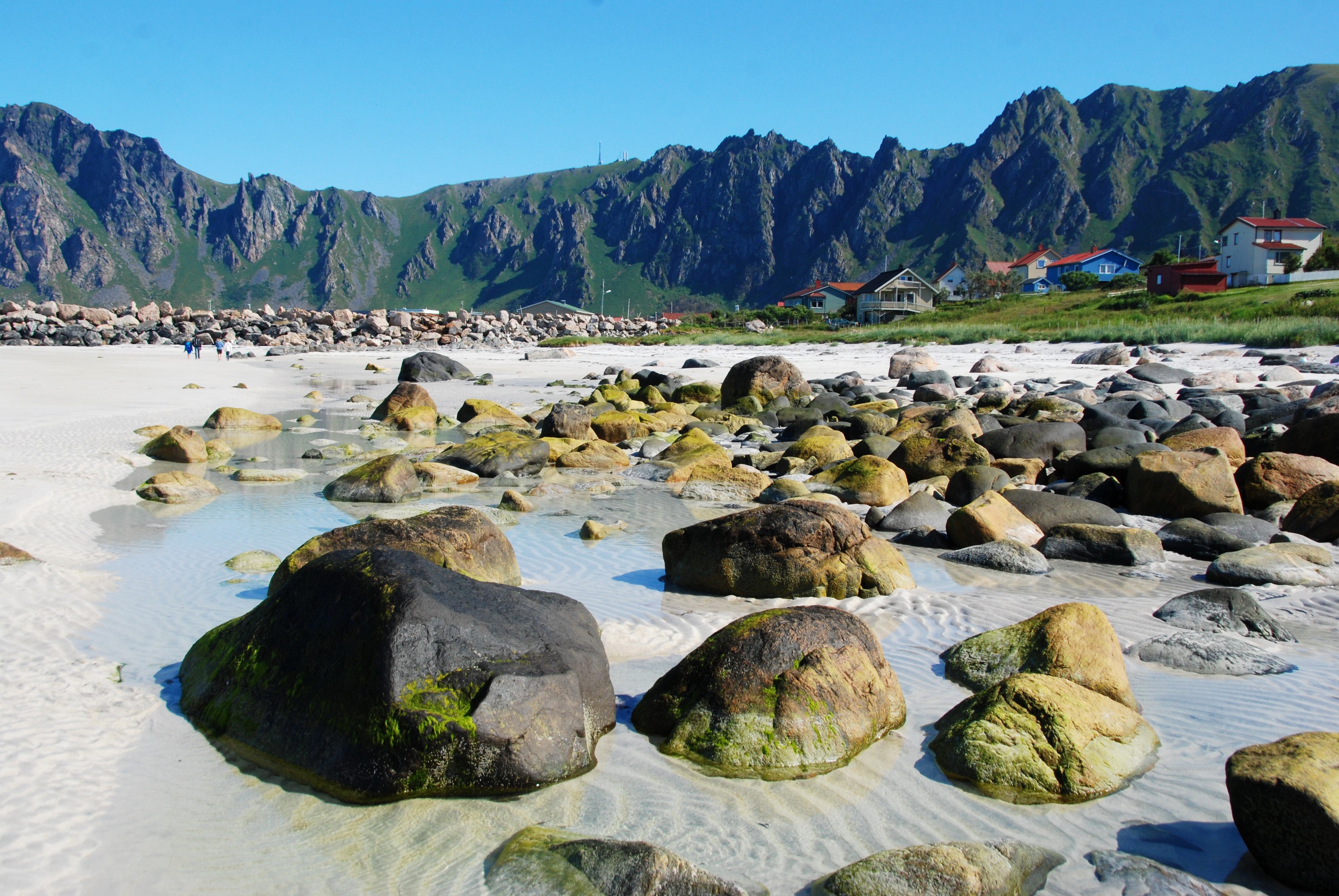 Rocky beach with mountains and houses in Andoy, Norway HD Wallpaper
