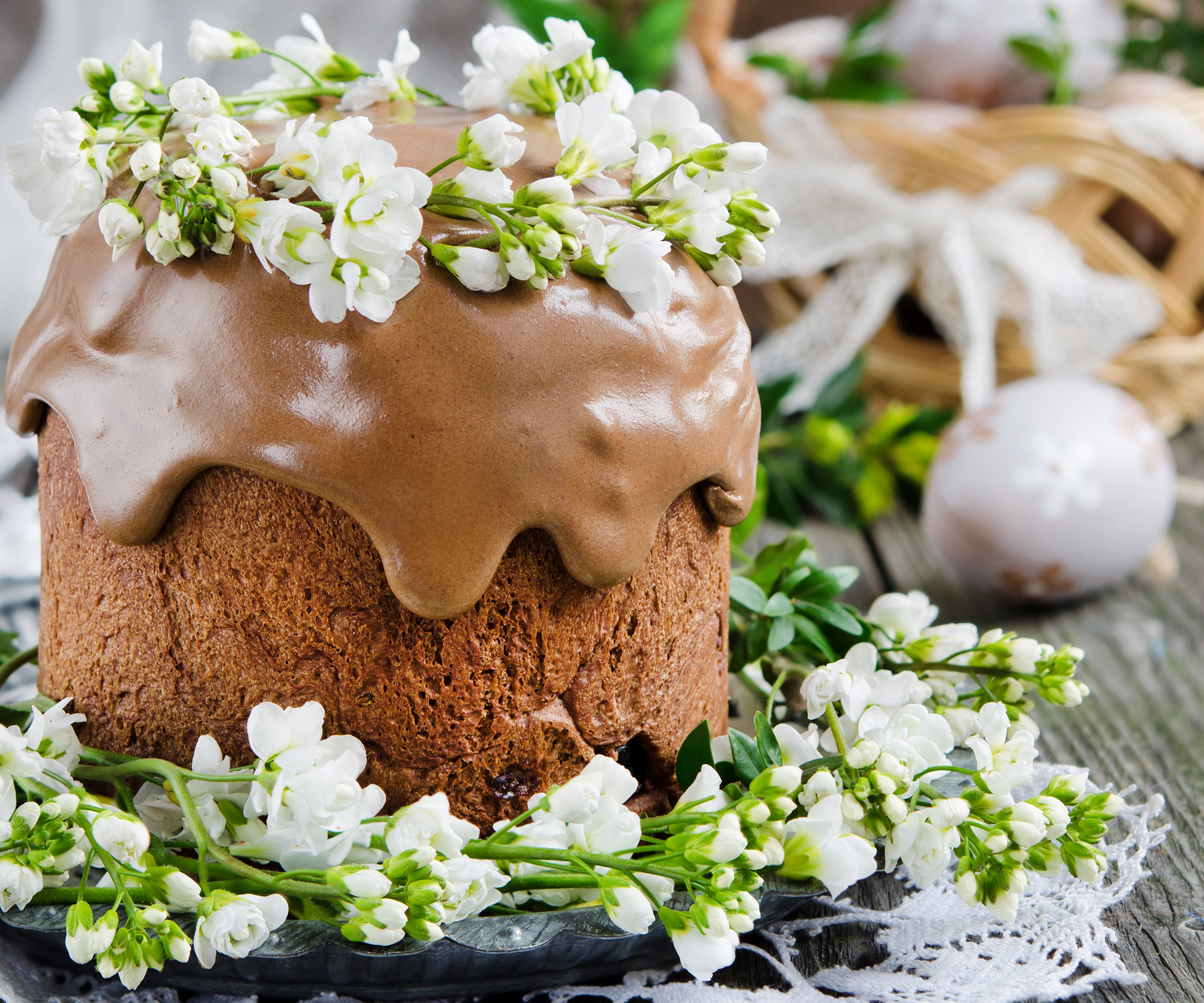 Easter cake decorated with chocolate glaze and white flowers HD Wallpaper