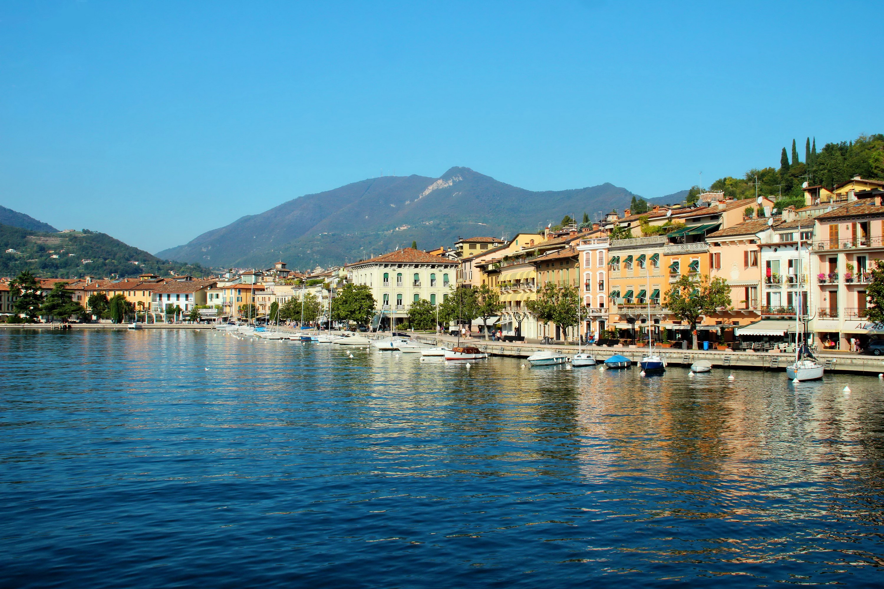 Salo Lombardy Italy waterfront with boats and mountains HD Wallpaper