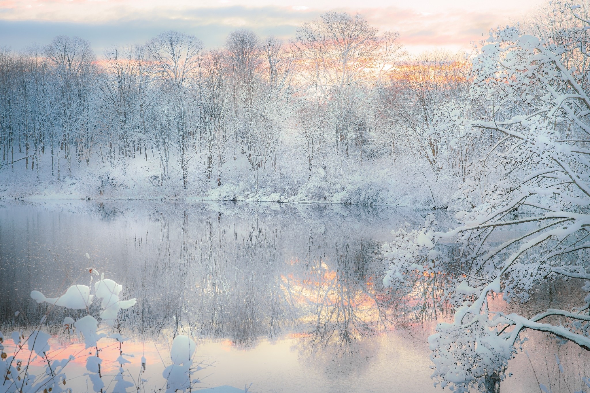 Two swans on a snowy lake at sunrise HD Wallpaper