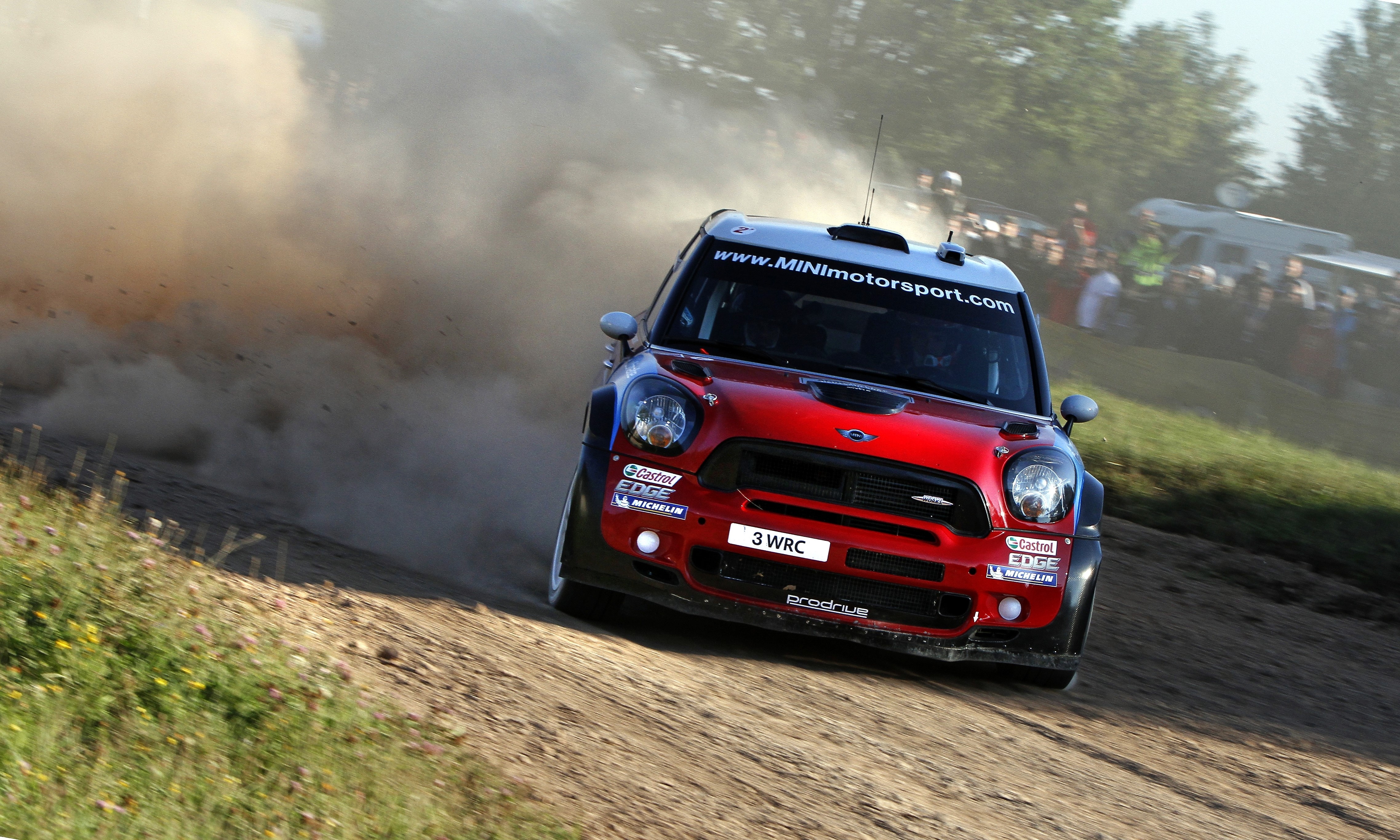 Red Mini WRC car on a dirt track HD Wallpaper