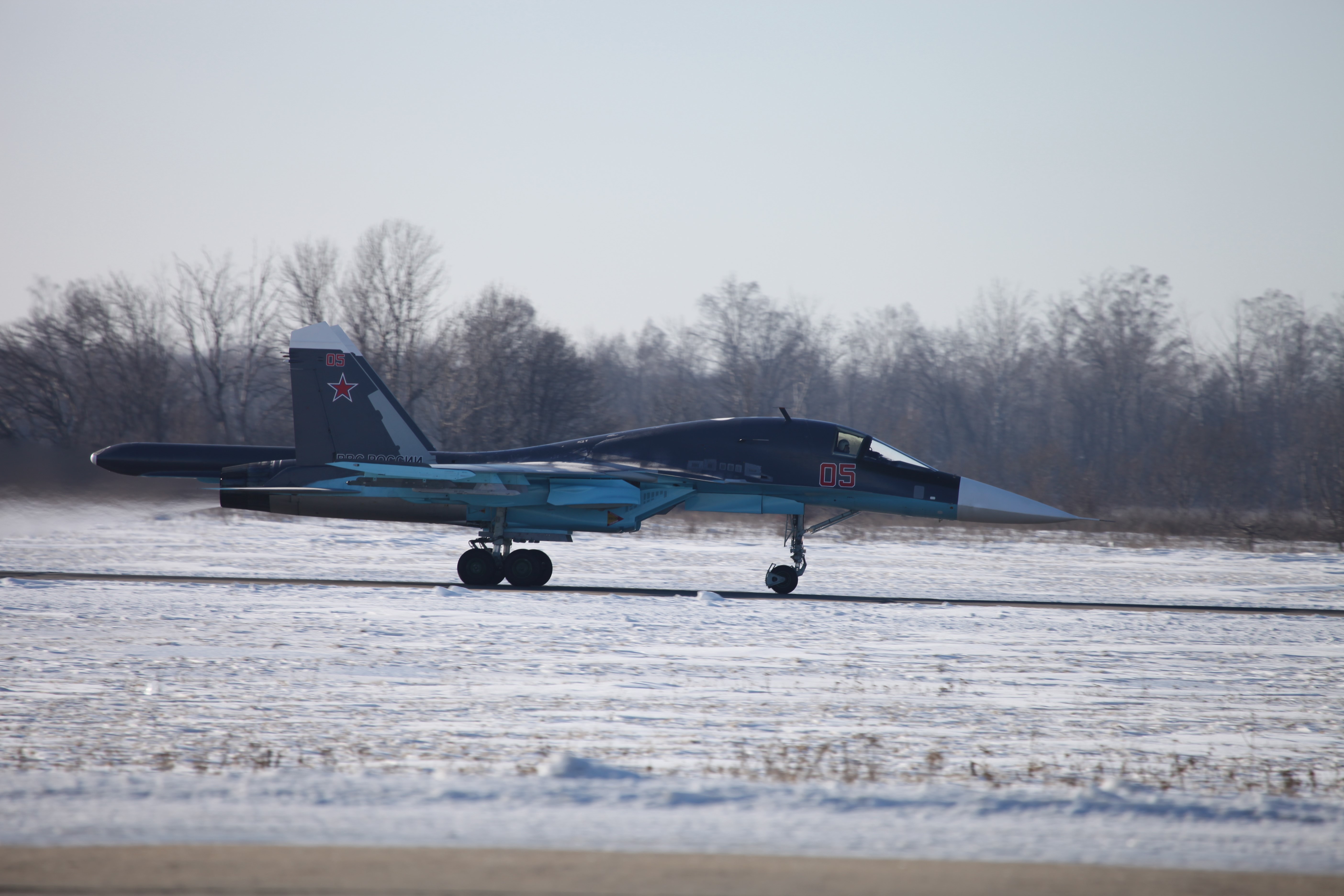 Sukhoi Su-34 fighter jet on a snowy runway HD Wallpaper