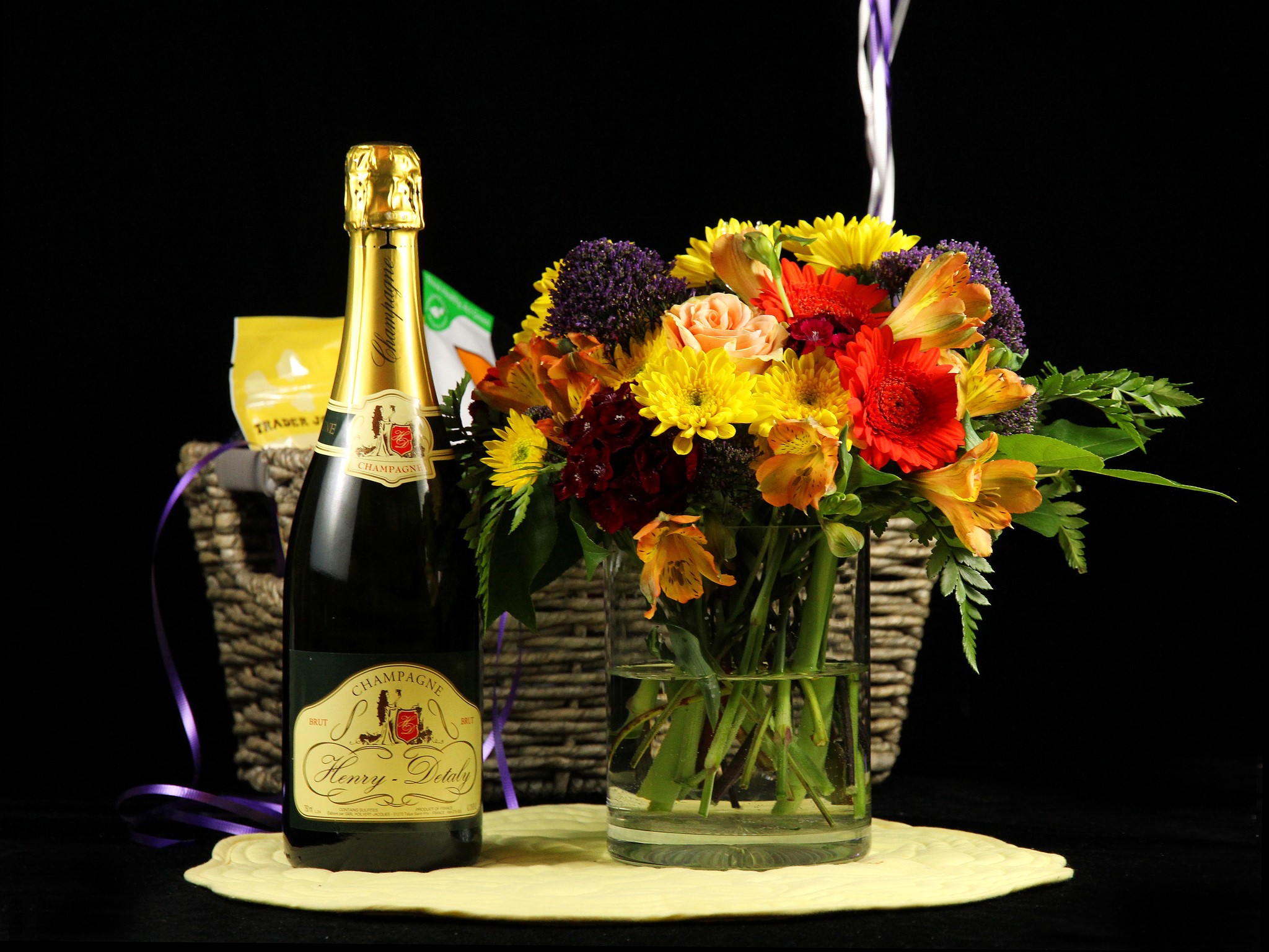Champagne bottle and flower bouquet in a basket HD Wallpaper