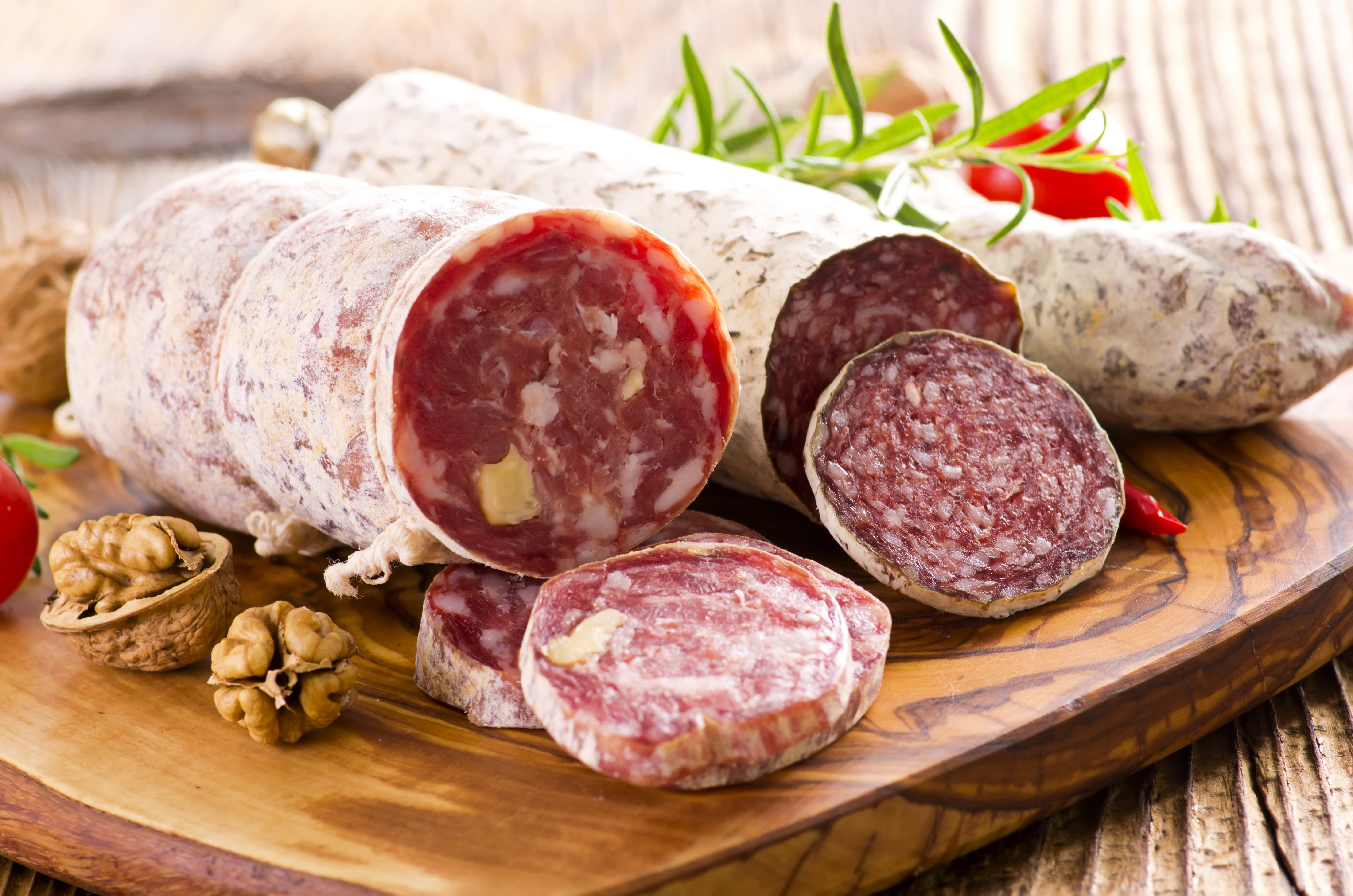 Sausage and walnuts on a wooden board HD Wallpaper