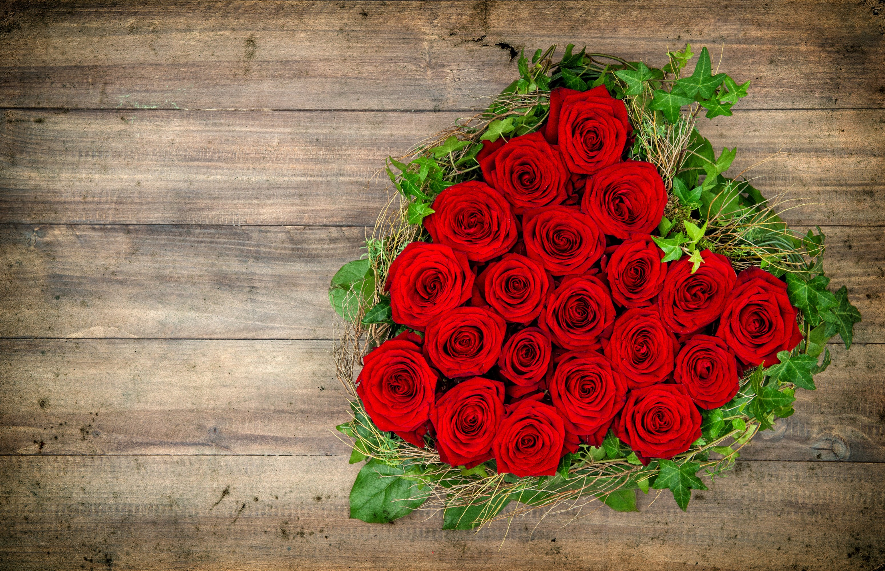 Heart-shaped arrangement of red roses with foliage HD Wallpaper