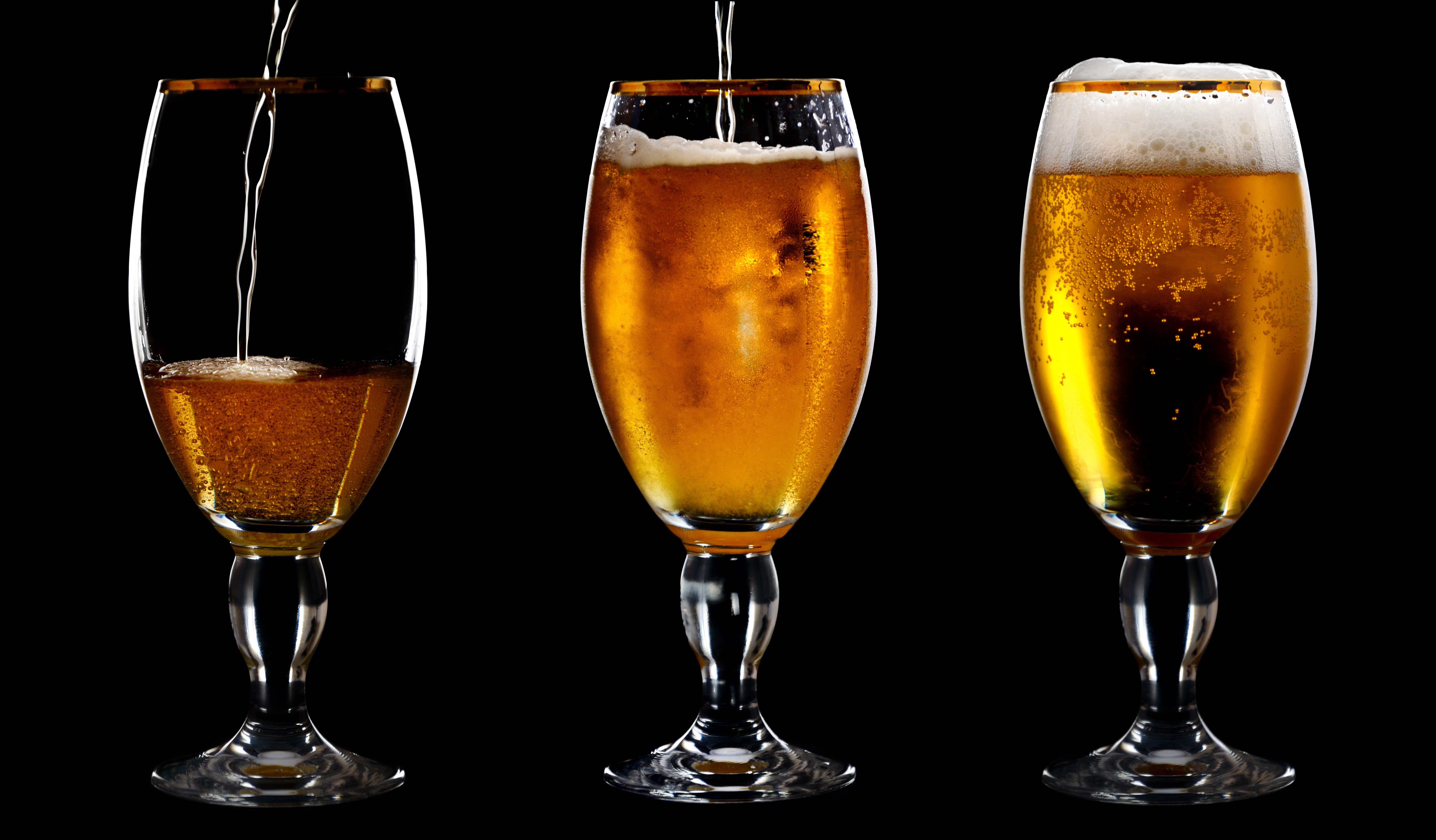 Three glasses of beer being poured HD Wallpaper