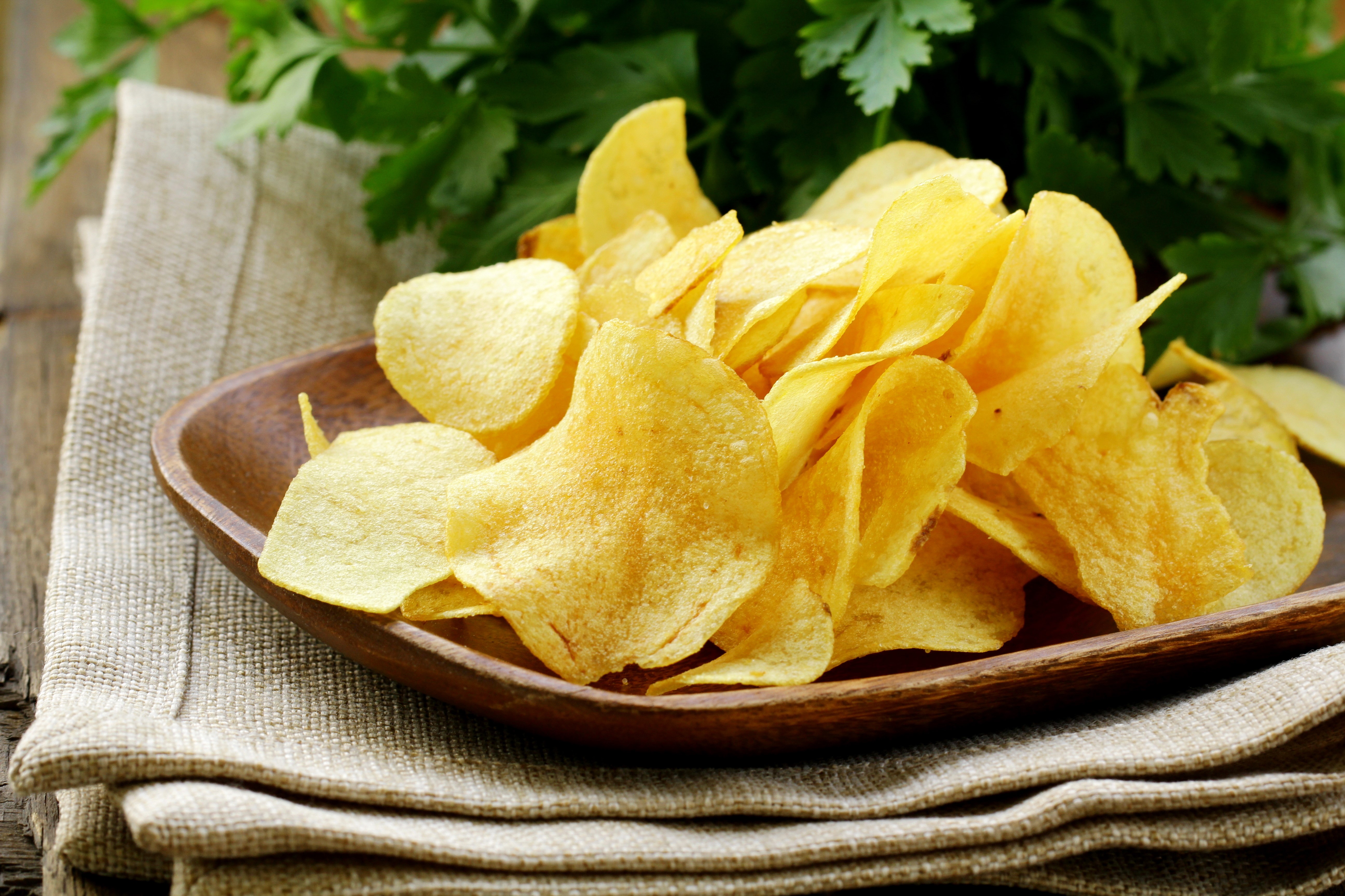 Potato chips in a wooden bowl with parsley HD Wallpaper