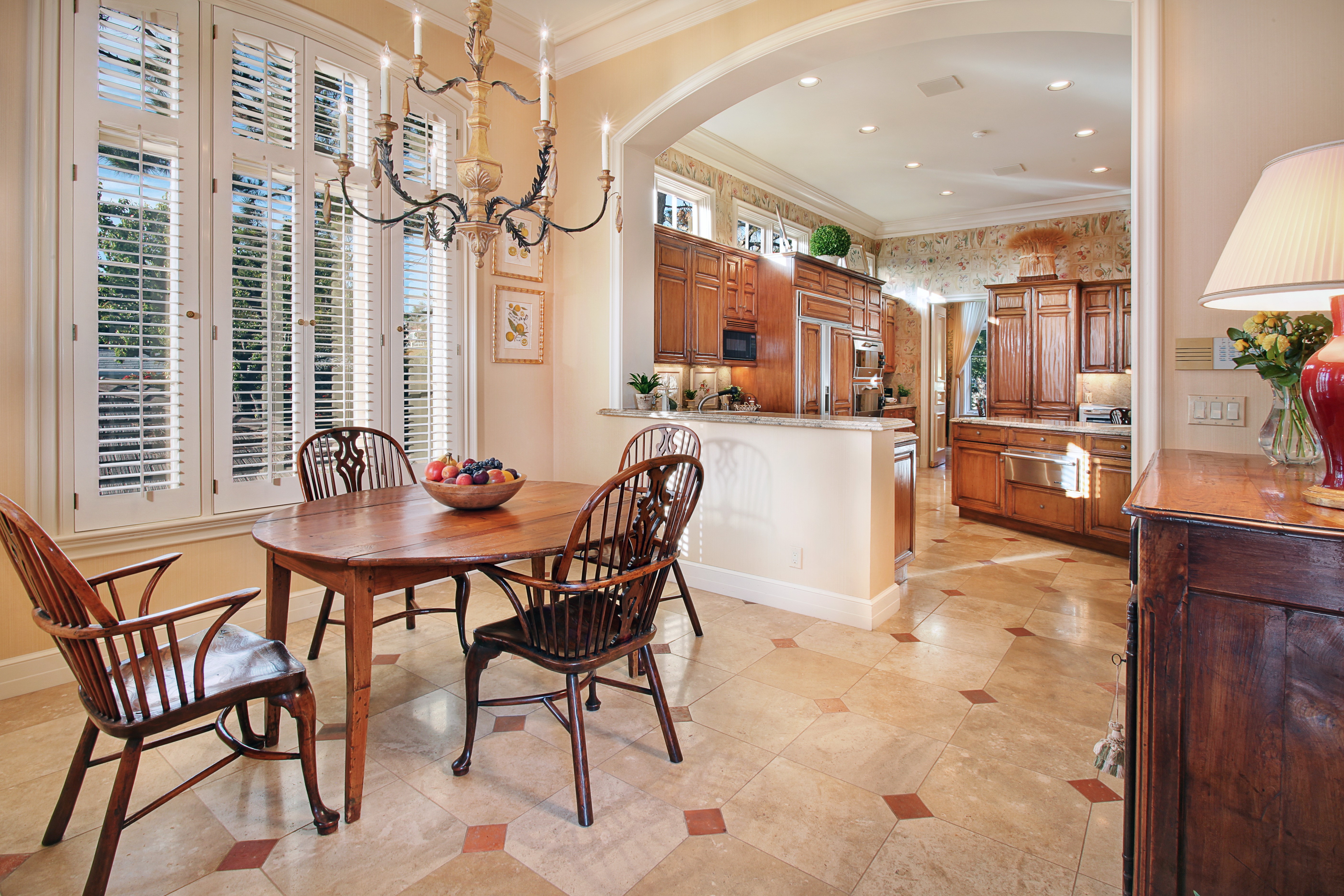 Dining area with chandelier and kitchen view HD Wallpaper