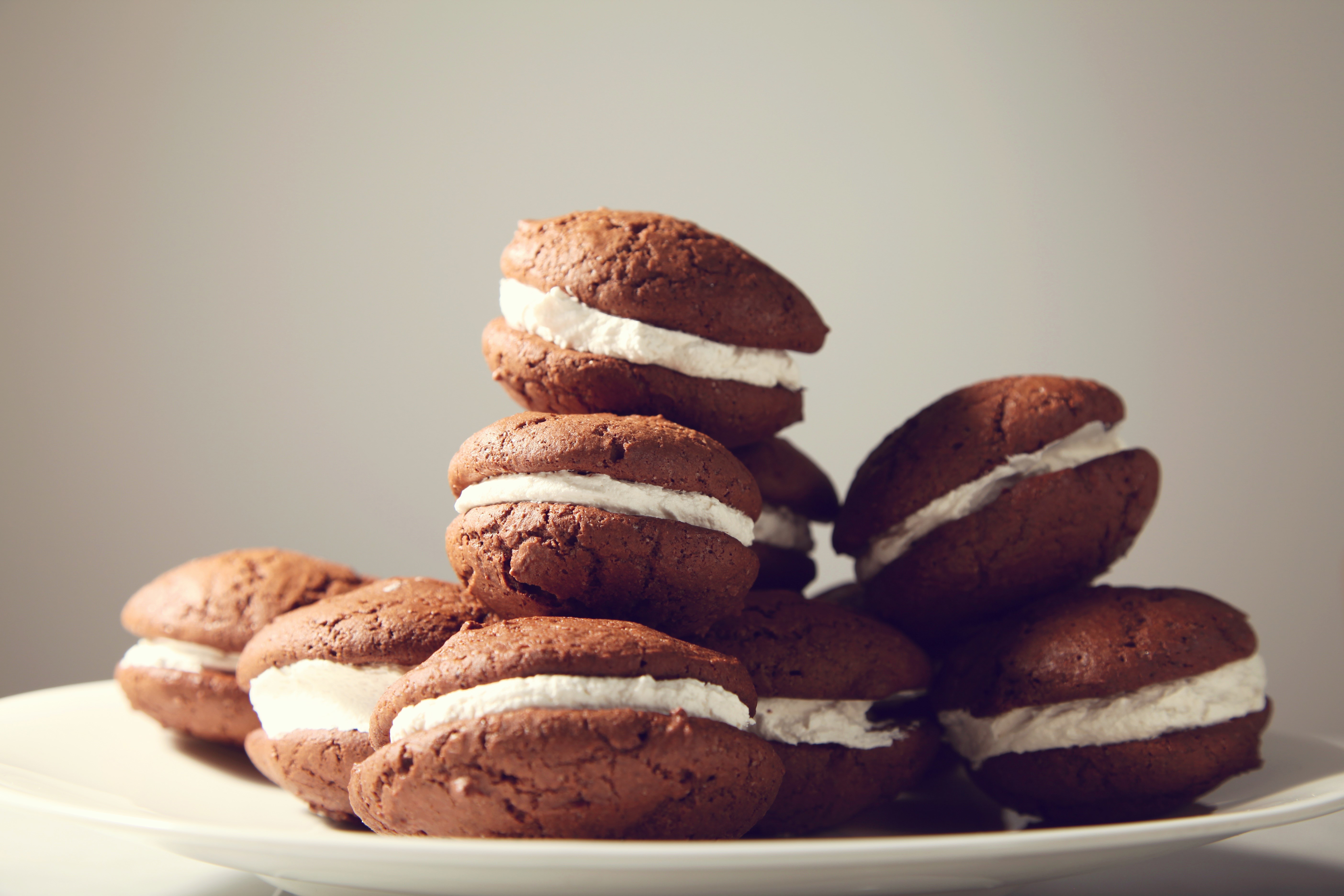 Chocolate Whoopie Pies with Cream Filling on a Plate HD Wallpaper