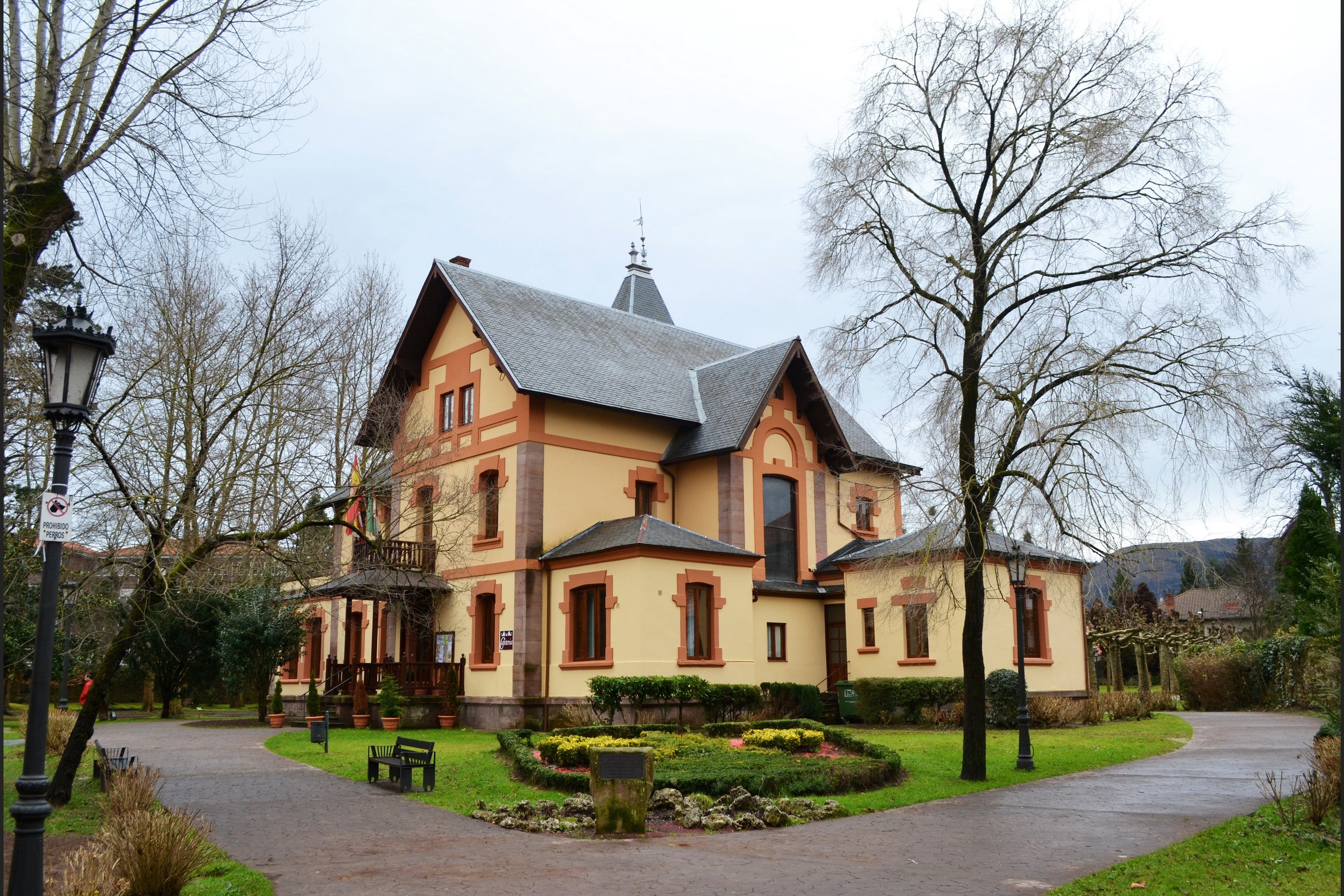 Yellow and brown house with a garden and trees HD Wallpaper